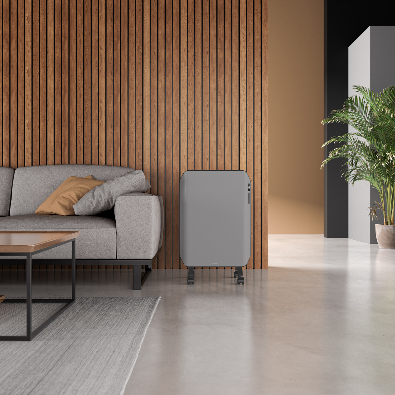 Woonkamer met grijze bank, houten muur, grijze kachel en plant. Een salontafel en een kleed staan vooraan.