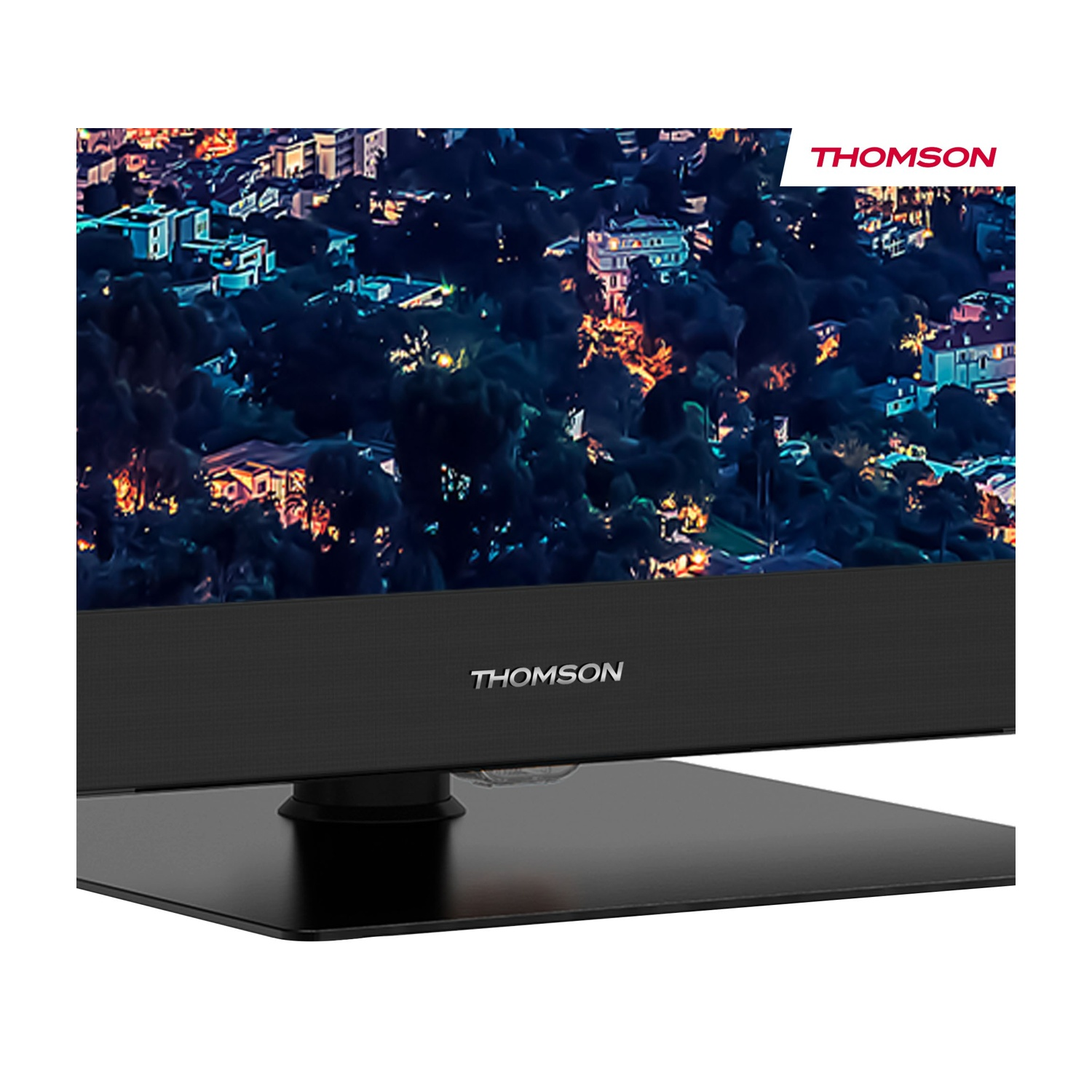 Un televisore Thomson mostra un paesaggio urbano notturno. La TV è nera con base nera. Il logo Thomson è visibile.