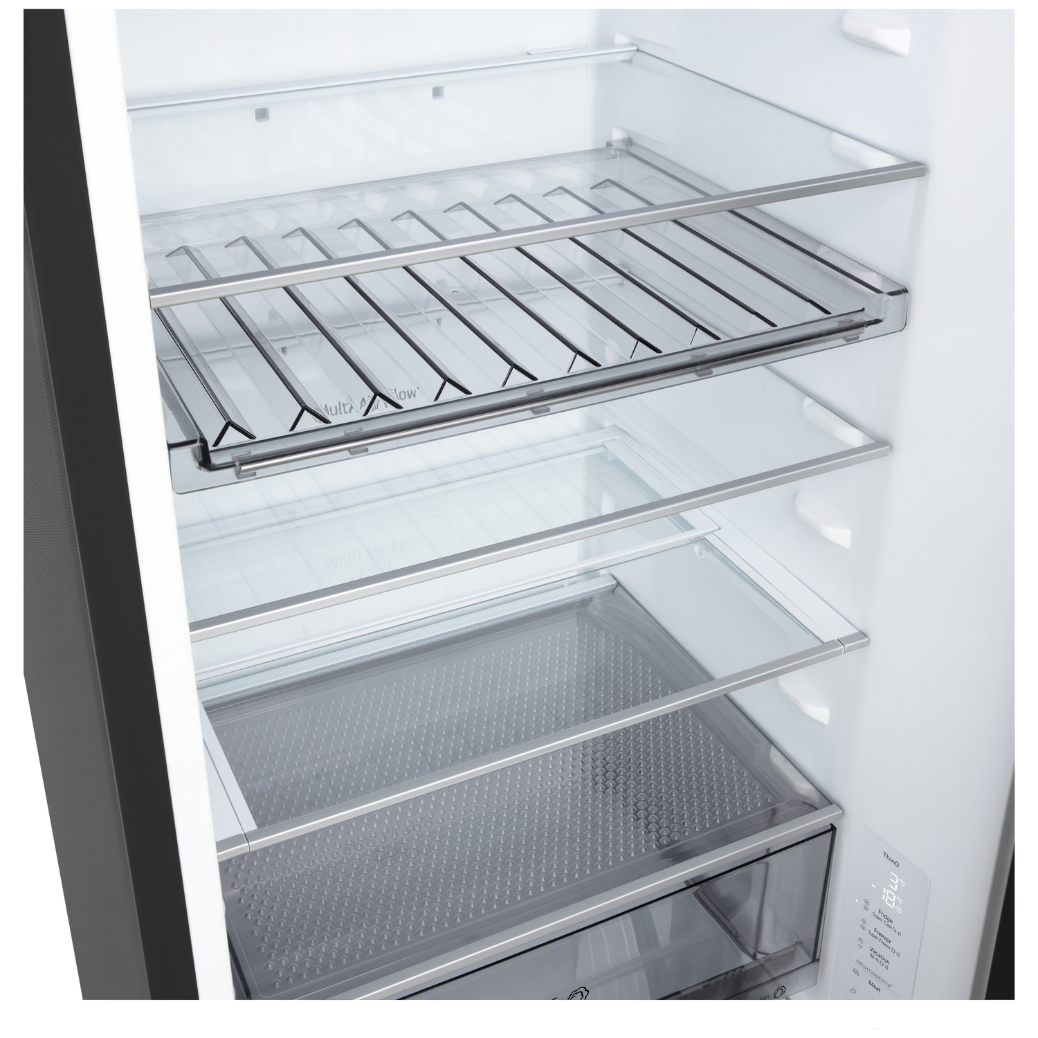 Inside a refrigerator, shelves made of glass and metal. The interior is white, with a drawer at the bottom. The door is dark grey.