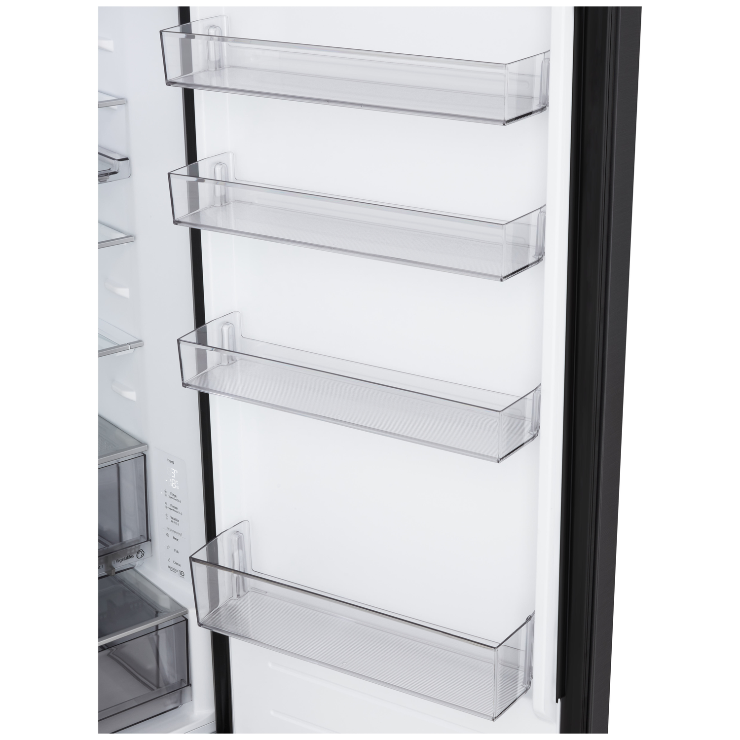Inside a refrigerator door. Clear plastic shelves are visible. The refrigerator is open with a white interior and black trim.