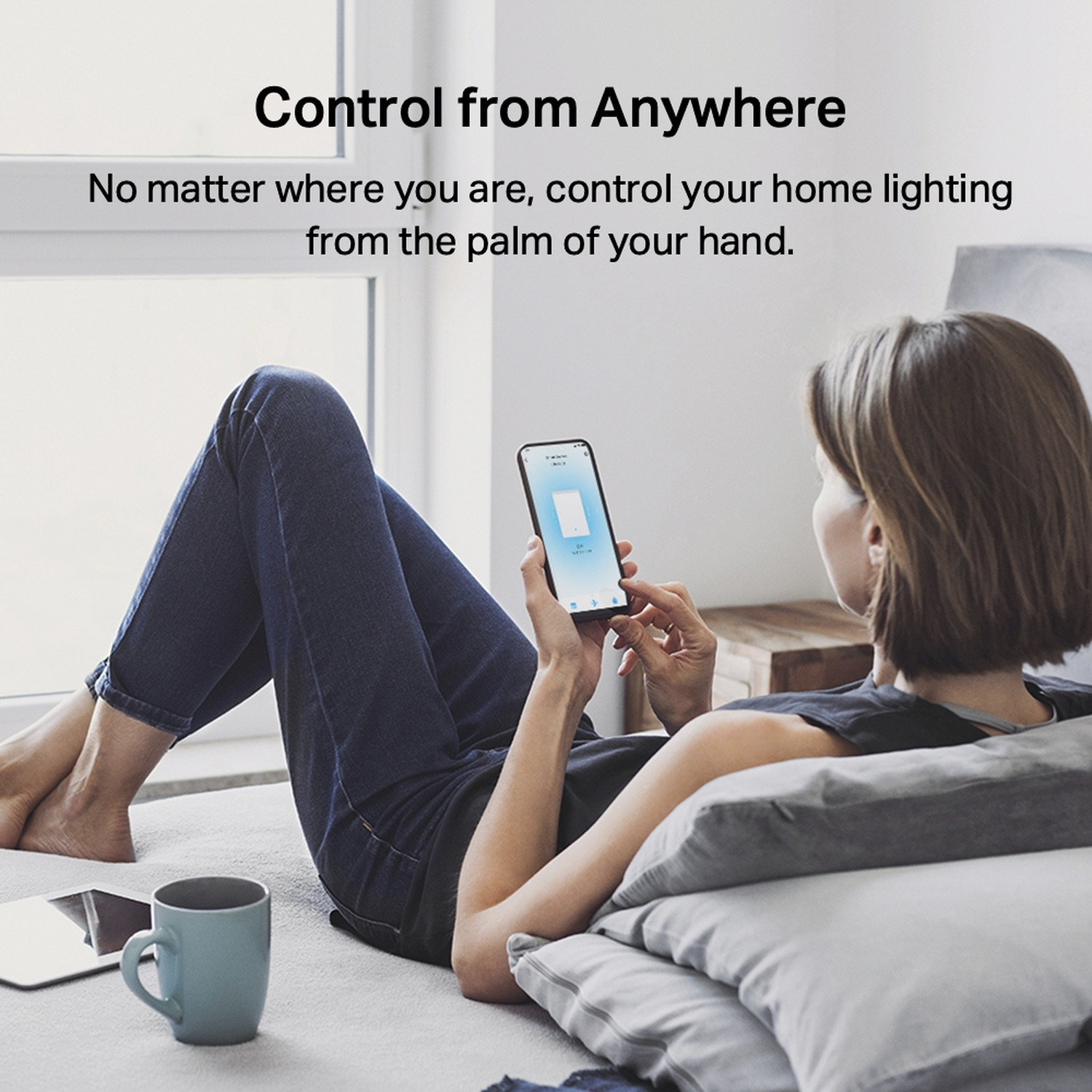 Woman lying on bed, using phone with smart home app. Text reads: Control from Anywhere. Tablet and mug are also visible.