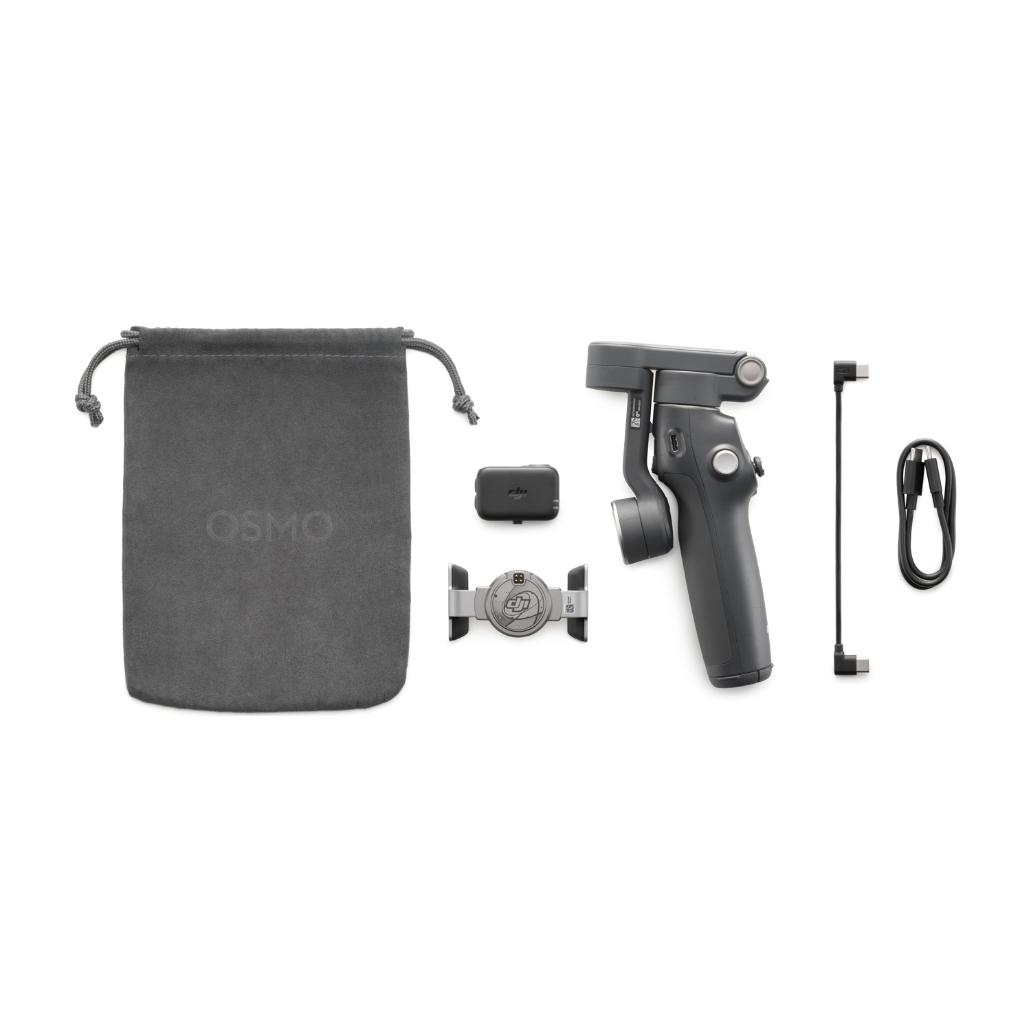 Un kit fotocamera Osmo grigio su una superficie bianca. Include custodia, gimbal, supporto, modulo wireless, cavo e caricabatterie.