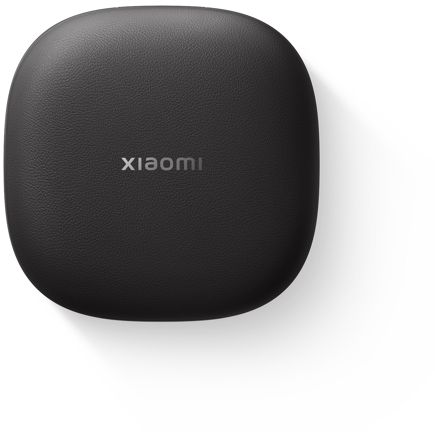 Een zwarte, ovale Xiaomi-hoes ligt op een wit oppervlak. De merknaam is zichtbaar. Een schaduw ligt ernaast.