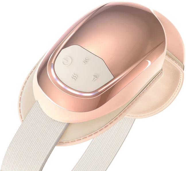 Roségold-Gesichtsmassagegerät mit Knöpfen und einem cremefarbenen Riemen. Es hat ein weißes Bedienfeld und eine cremefarbene Kunstlederbasis.