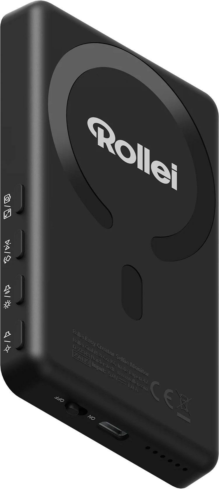 Ein schwarzer Rollei Selfie-Monitor. Merkmale sind Tasten, ein Netzschalter und das Rollei-Logo. Enthält technische Details.