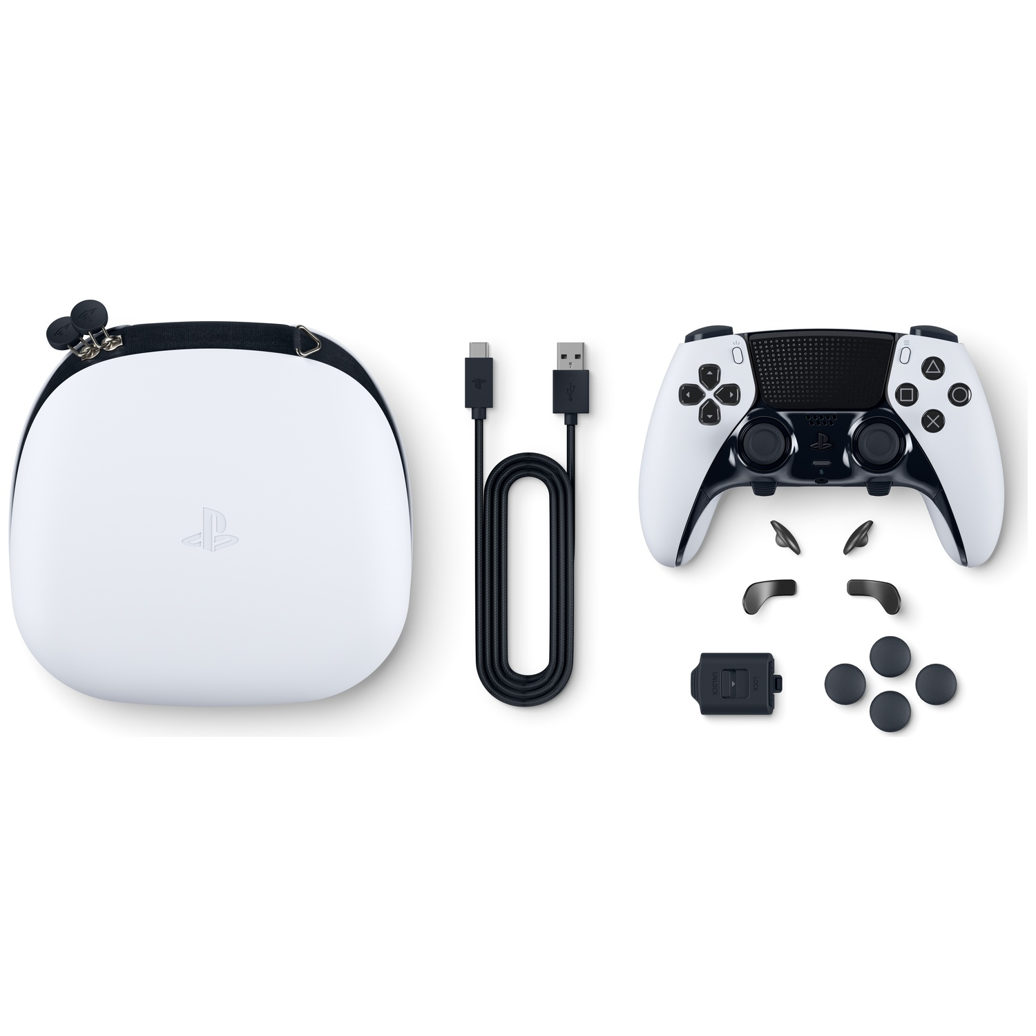 A white and black Playstation controller with accessories. Includes a carrying case, USB cable, extra buttons, and paddles.