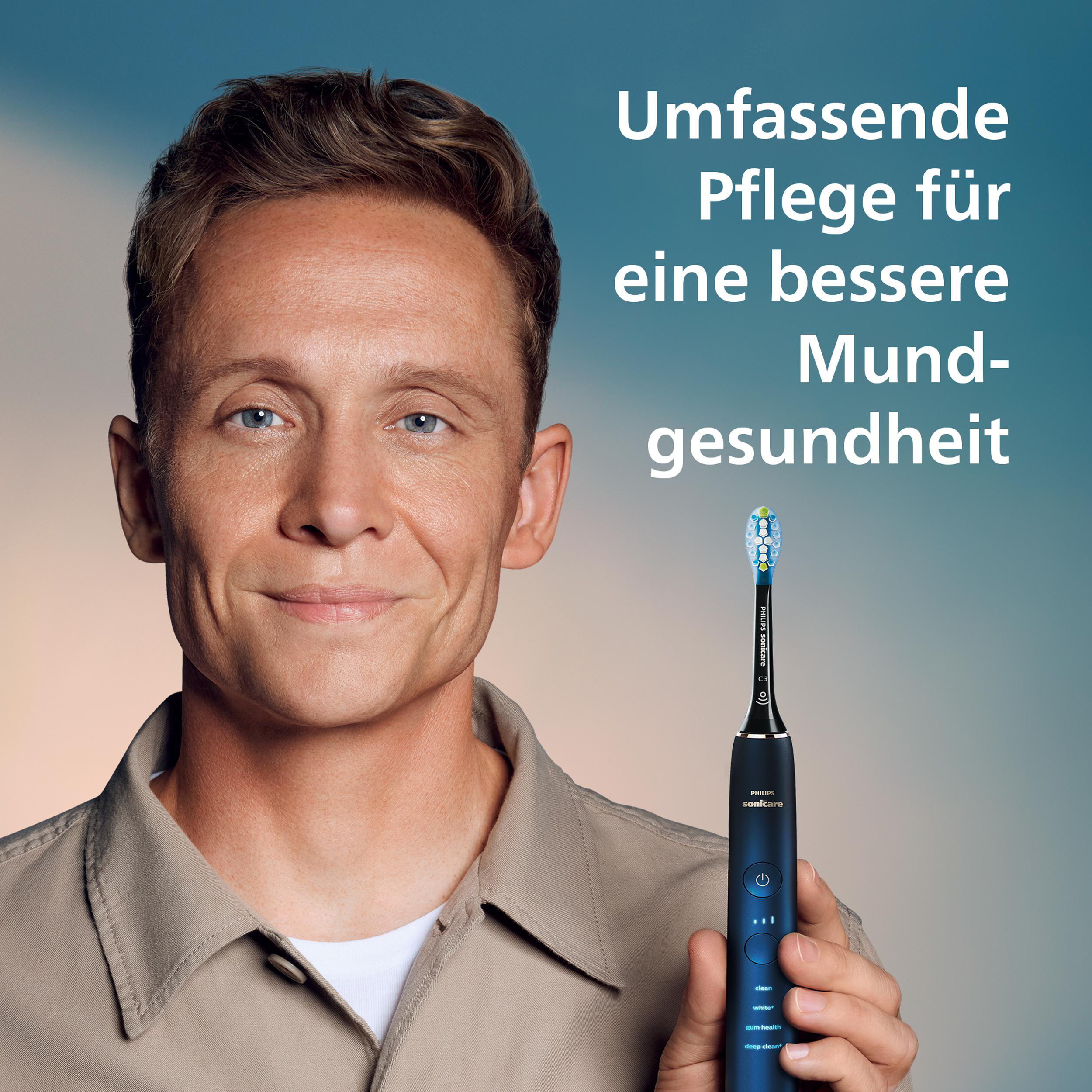 Mann hält blaue Philips Sonicare Zahnbürste. Text auf Deutsch bewirbt Mundgesundheit. Hintergrund blau.