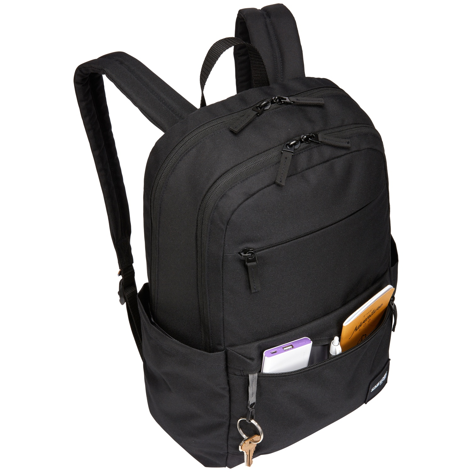 Sac à dos noir avec plusieurs poches. Contient un carnet, des clés et un téléphone. Fermetures éclair visibles.