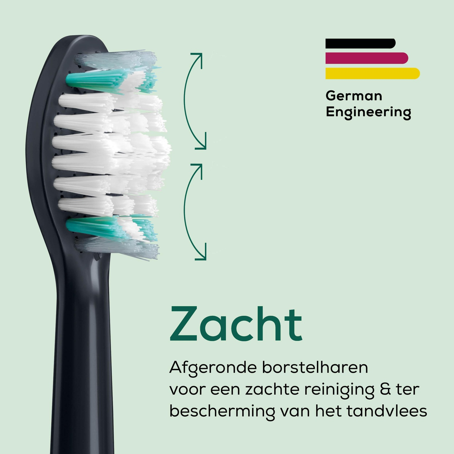 A close-up of a black toothbrush head with white and green bristles. The text says 'Zacht' and 'German Engineering'.