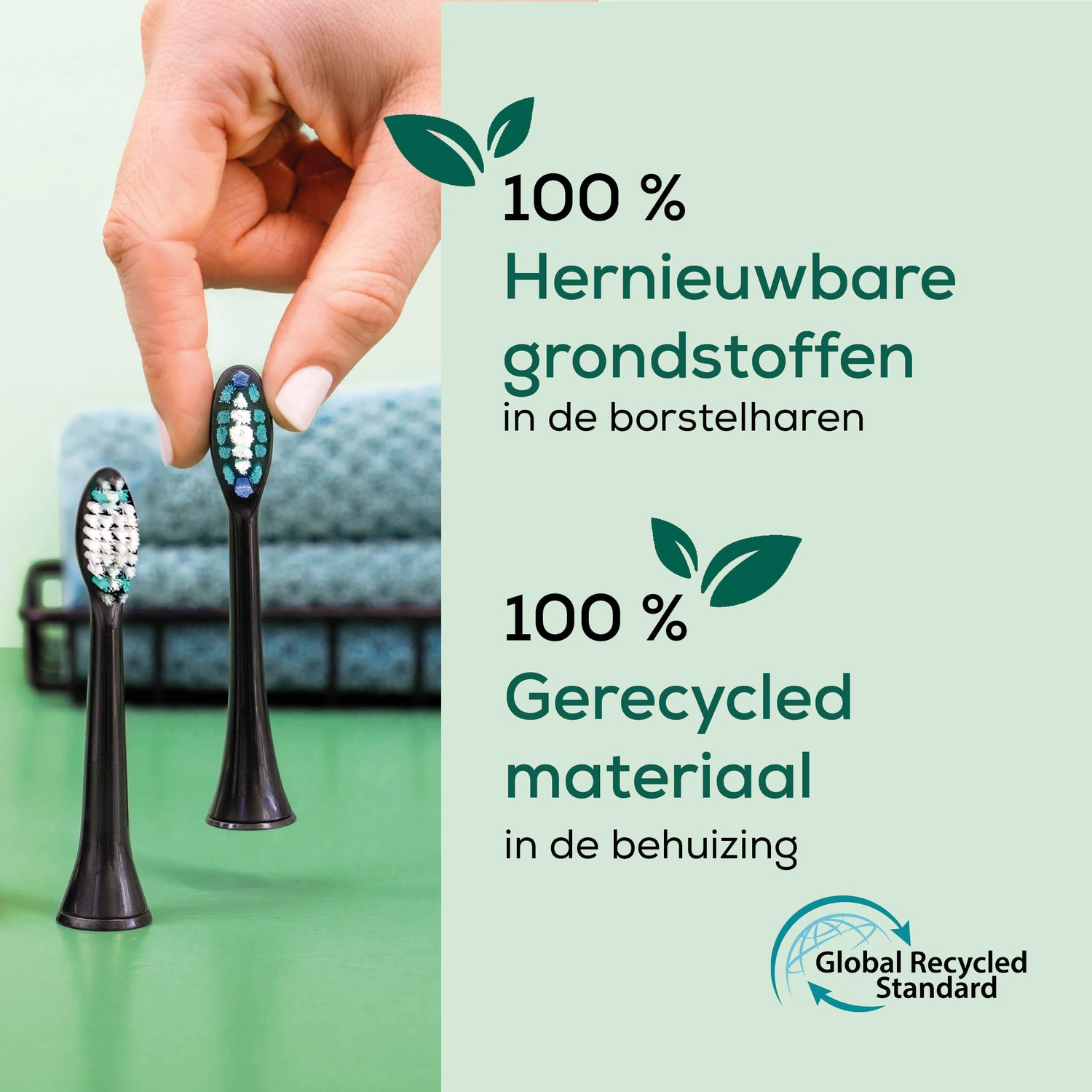 A hand holds a toothbrush head. Two other toothbrush heads are in the foreground. Text states 100% renewable materials and recycled materials.