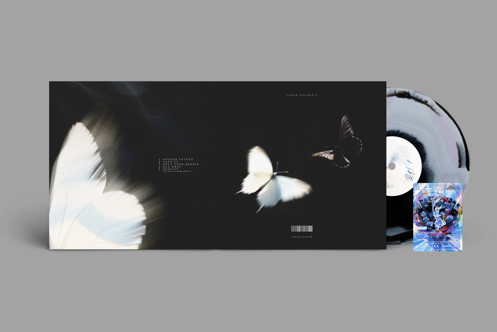 Albumcover: Vinylplatte mit Schmetterlingskunst, eine Karte mit blauer Kunst und ein Graustufen-Hintergrund.