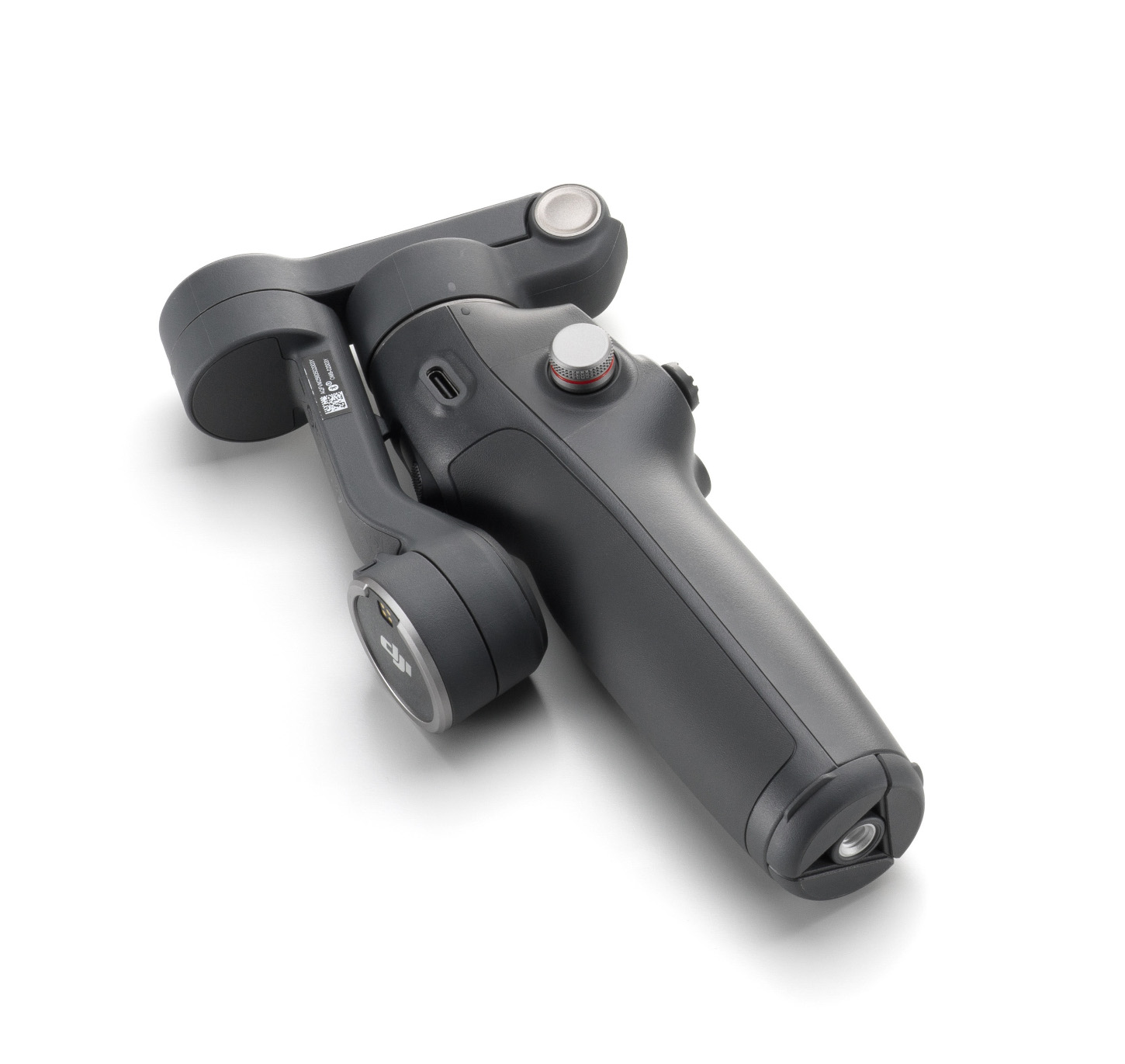 Szary, ręczny stabilizator gimbala na białej powierzchni. Ma przyciski, uchwyt i obrotowe ramię do kamer.