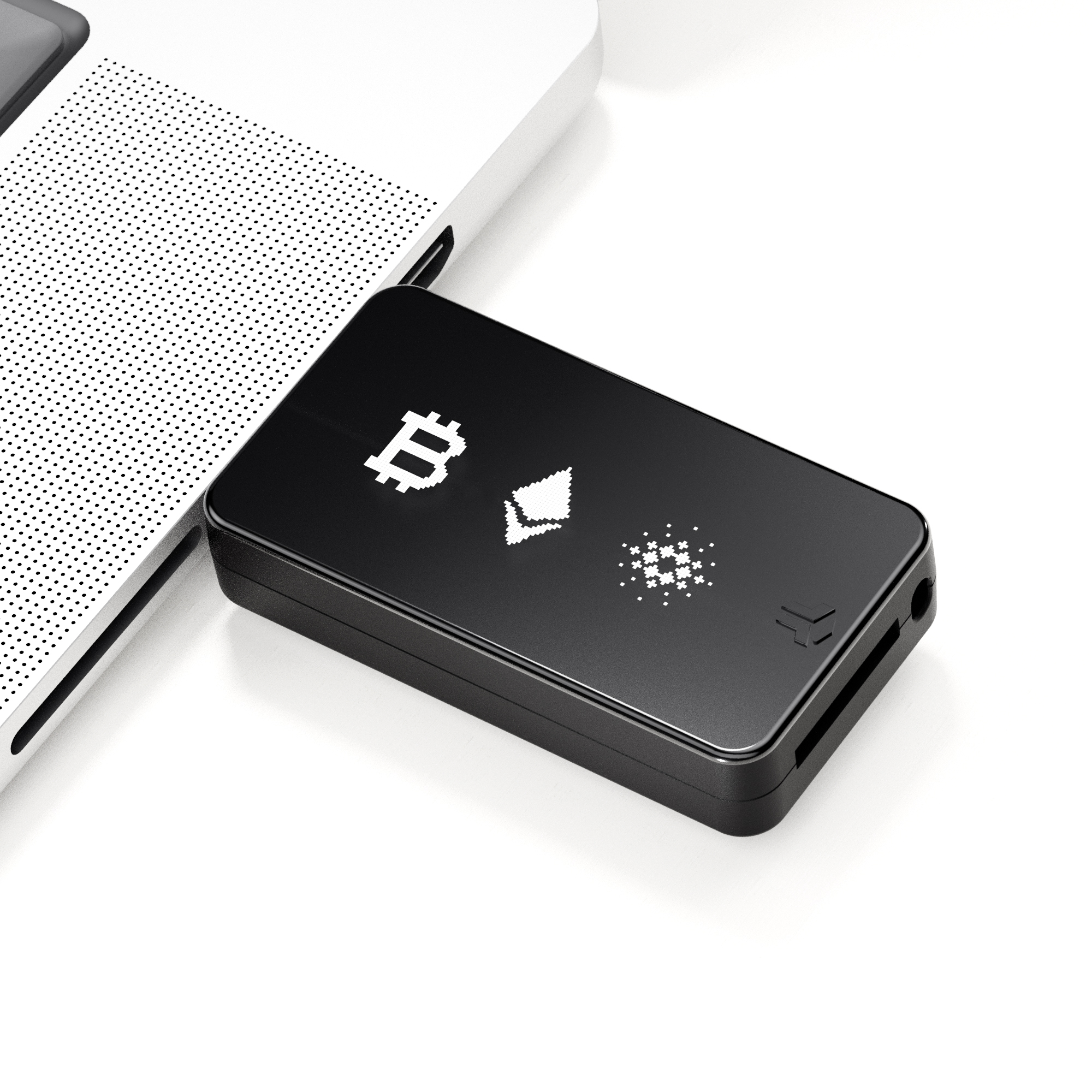 Schwarzes Krypto-Hardware-Wallet mit Bitcoin-, Ethereum- und Cardano-Symbolen auf einem weißen Laptop.