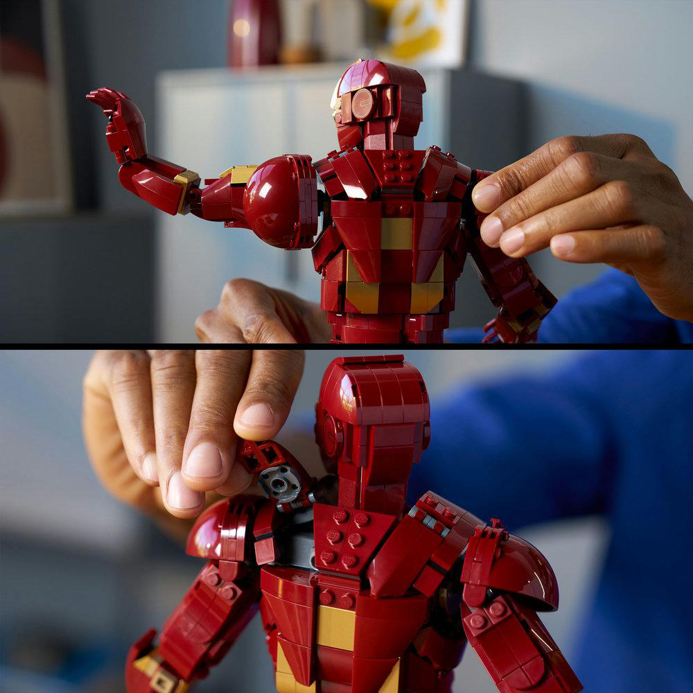 Eine Person baut eine rot-goldene Lego-Iron-Man-Figur zusammen. Hände werden beim Bau der Figur gezeigt. Der Hintergrund hat Möbel.