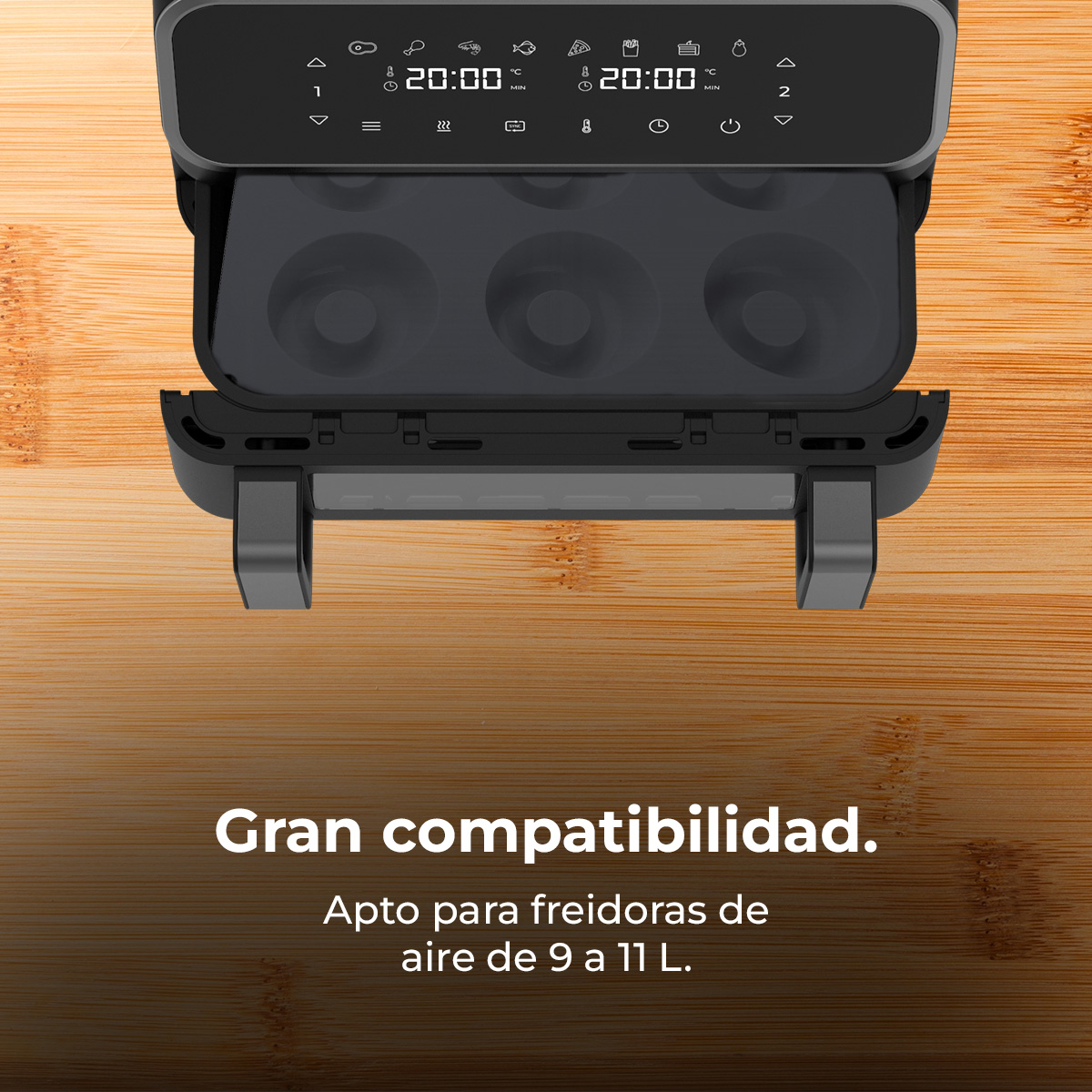 Freidora de aire negra con pantalla digital y bandeja con formas de rosquillas, sobre una superficie de madera. Texto: Gran compatibilidad.