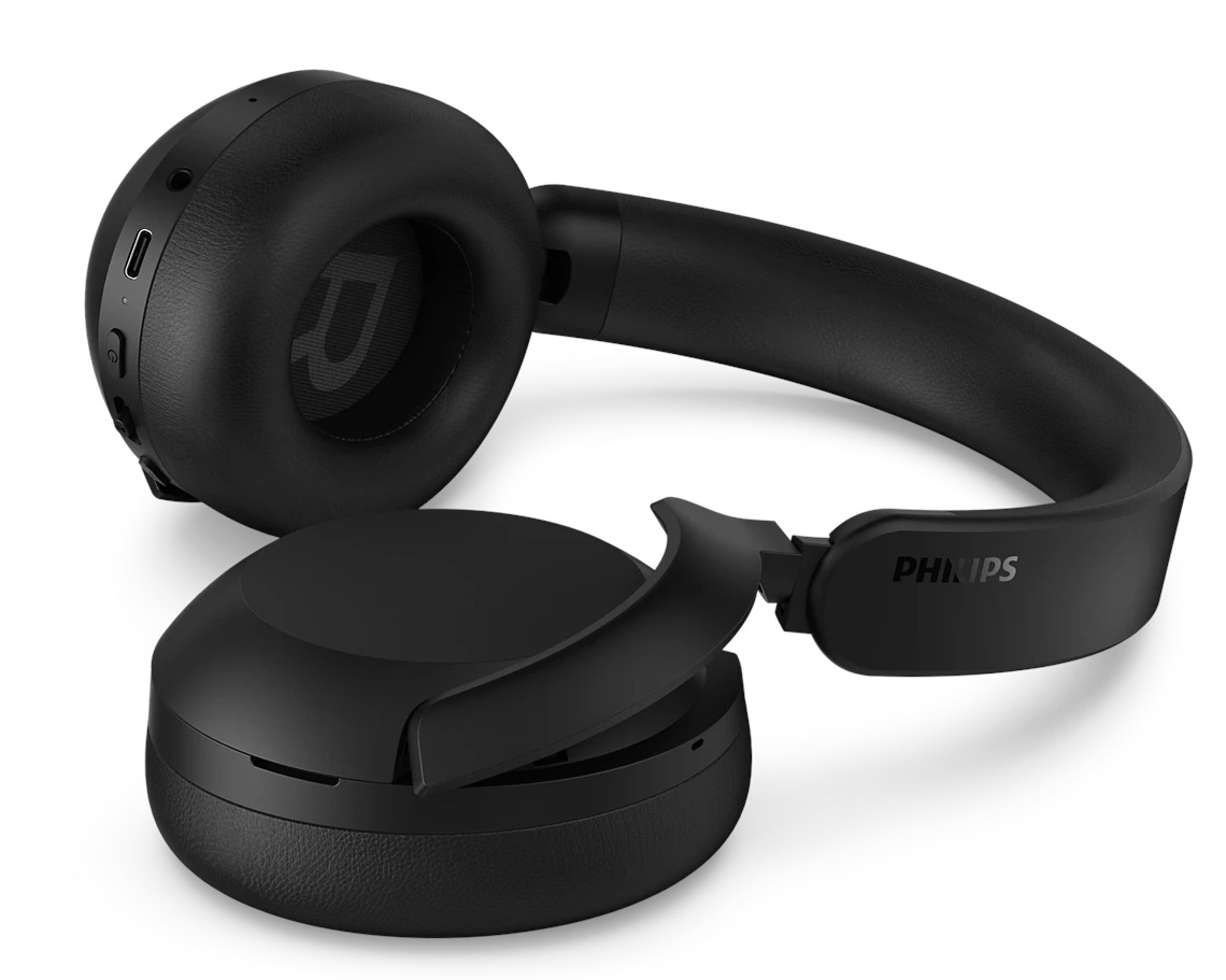 Czarne słuchawki Philips, częściowo zdemontowane, spoczywające na białej powierzchni. Widoczne słowo "PHILIPS".