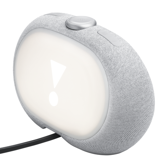 Szary, inteligentny budzik pokryty tkaniną z białym wyświetlaczem świetlnym, pokazującym wykrzyknik i przyciski sterujące.