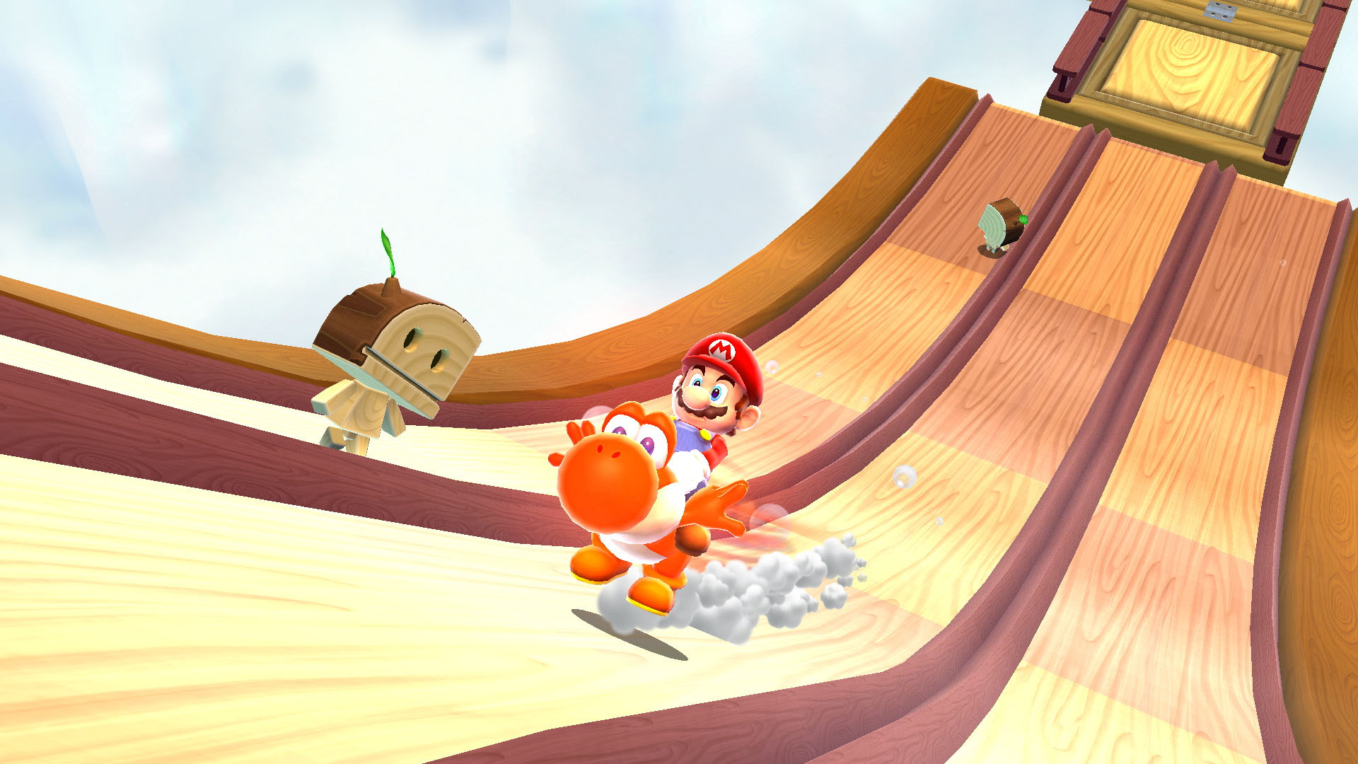 Mario, Yoshi ile ahşap bir kaydıraktan aşağı kayıyor. Ahşap bir karakter de kayıyor. Arka plan açık mavi bir gökyüzü.