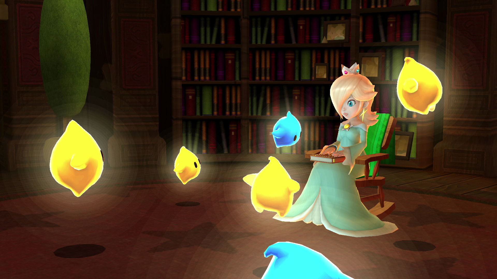 Rosalina, bir kitap tutan Lumas'larla bir kütüphanede. Sarı ve mavi Lumas'lar etrafında uçuyor. Arka planda kitaplıklar.