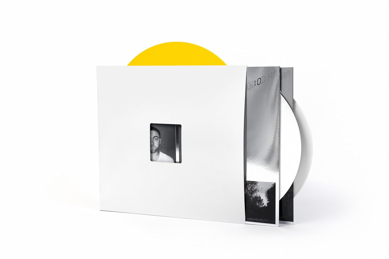 Album borító: Fehér tok, négyzet alakú kivágással, amely egy férfi arcát mutatja. Sárga bakelit látszik. Ezüst album látható.