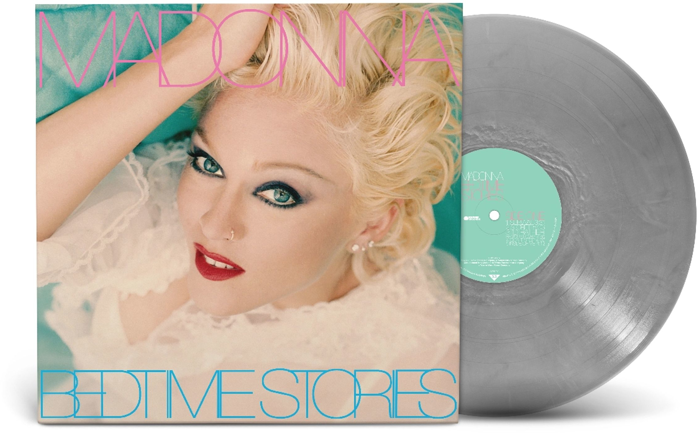 Madonna az album borítóján. Szőke haj, piros rúzs és kék szemfesték. Vinyl lemez a borítótól jobbra.