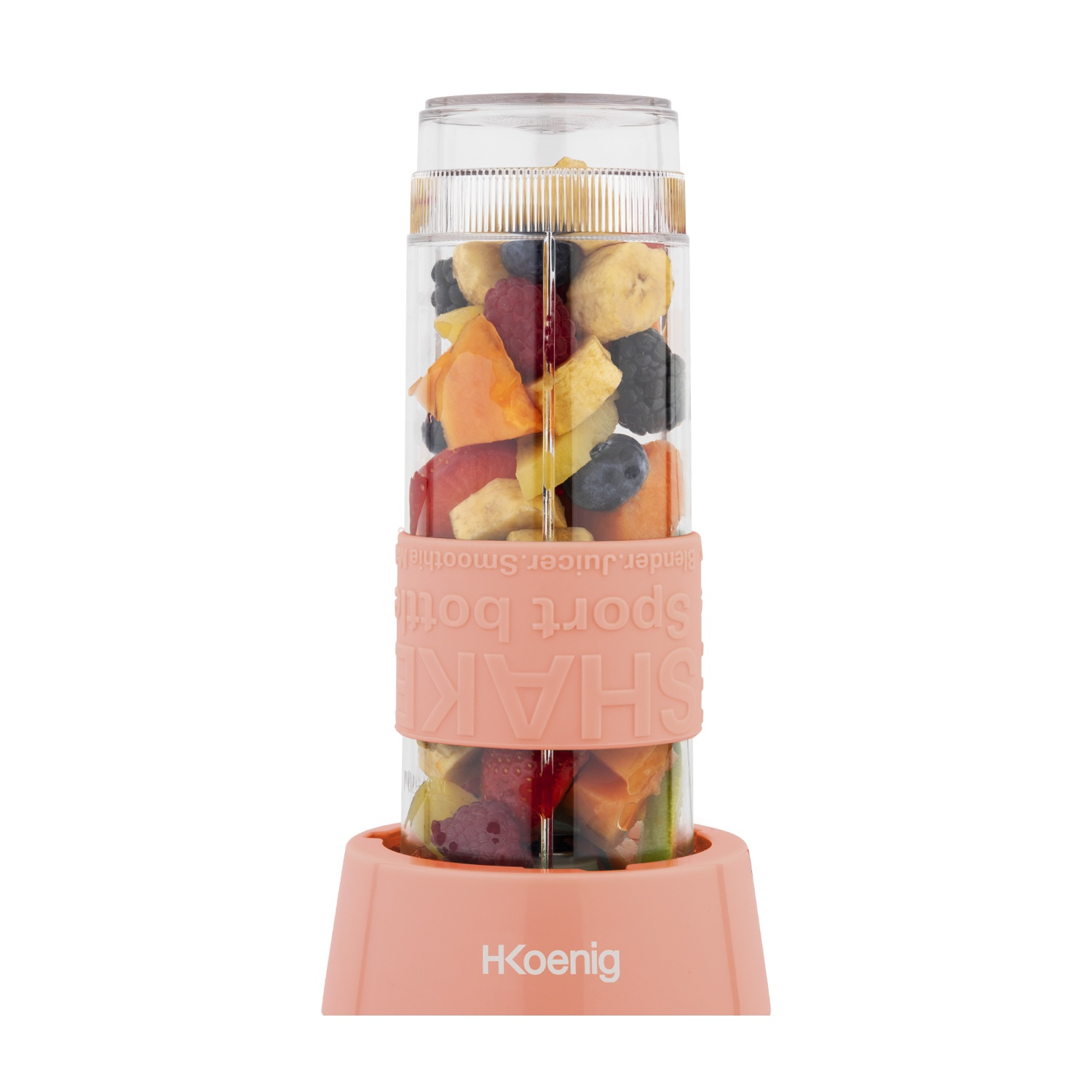 Un frullatore trasparente pieno di frutta tagliata come bacche, banane e arance. Poggia su una base rosa con scritto 'HKoenig'.