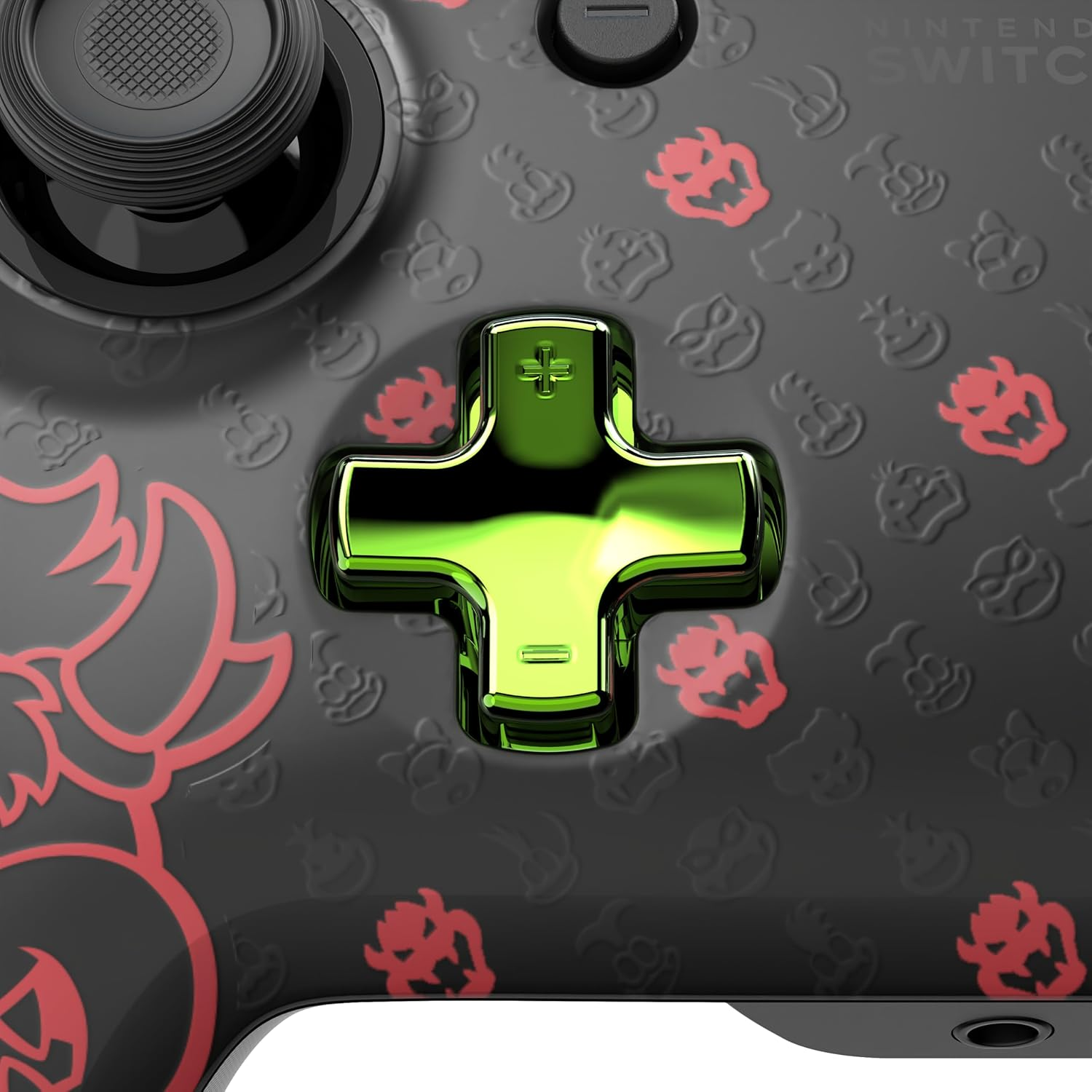 Nintendo Switch controller with a green cross-shaped D-pad. Black base with red Bowser and character patterns.