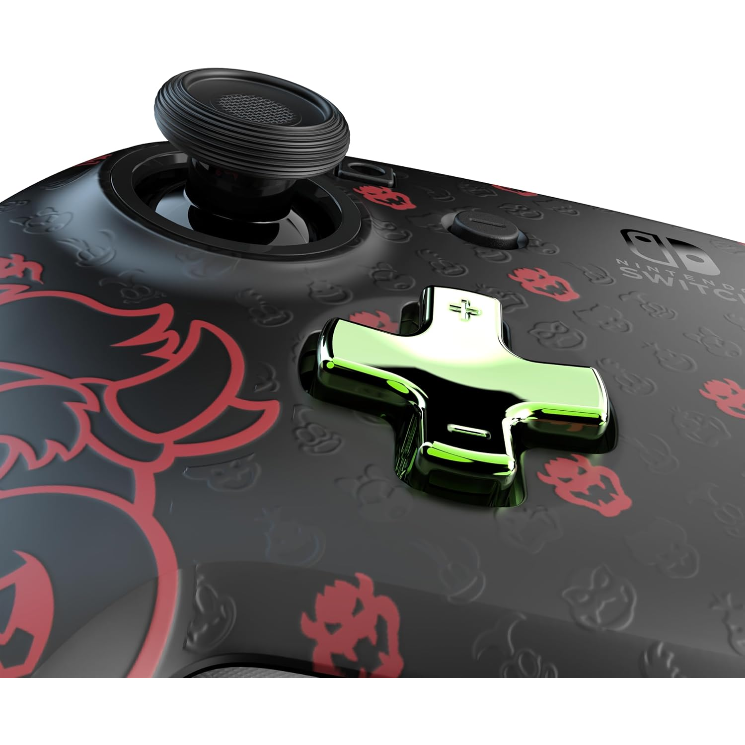 A Nintendo Switch controller with a black base, red Bowser designs, and a green directional pad. A black joystick is also visible.