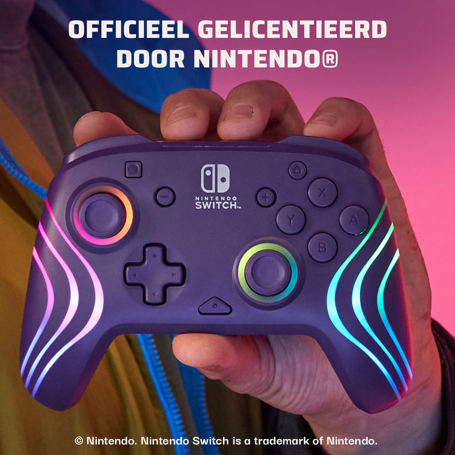 Een paarse Nintendo Switch-controller wordt vastgehouden. Het heeft gekleurde lichten en knoppen. De achtergrond is roze en paars.