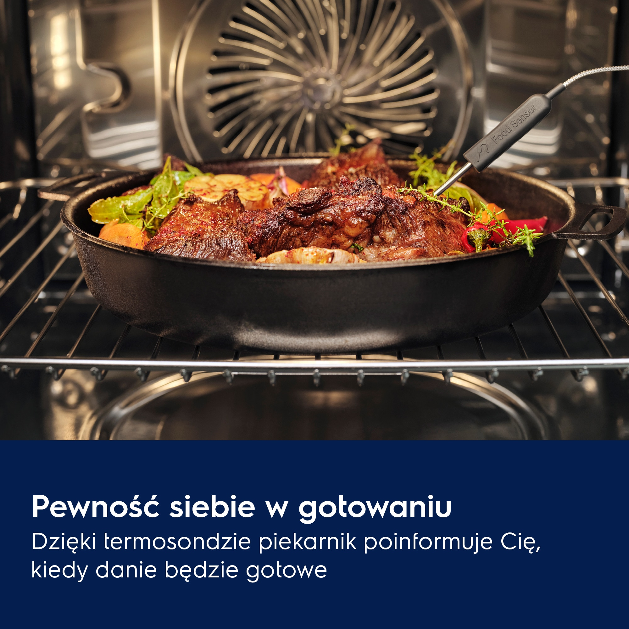 W piekarniku, żeliwny garnek z pieczonym mięsem i warzywami. Włożony czujnik żywności. Tekst: Pewność siebie w gotowaniu.