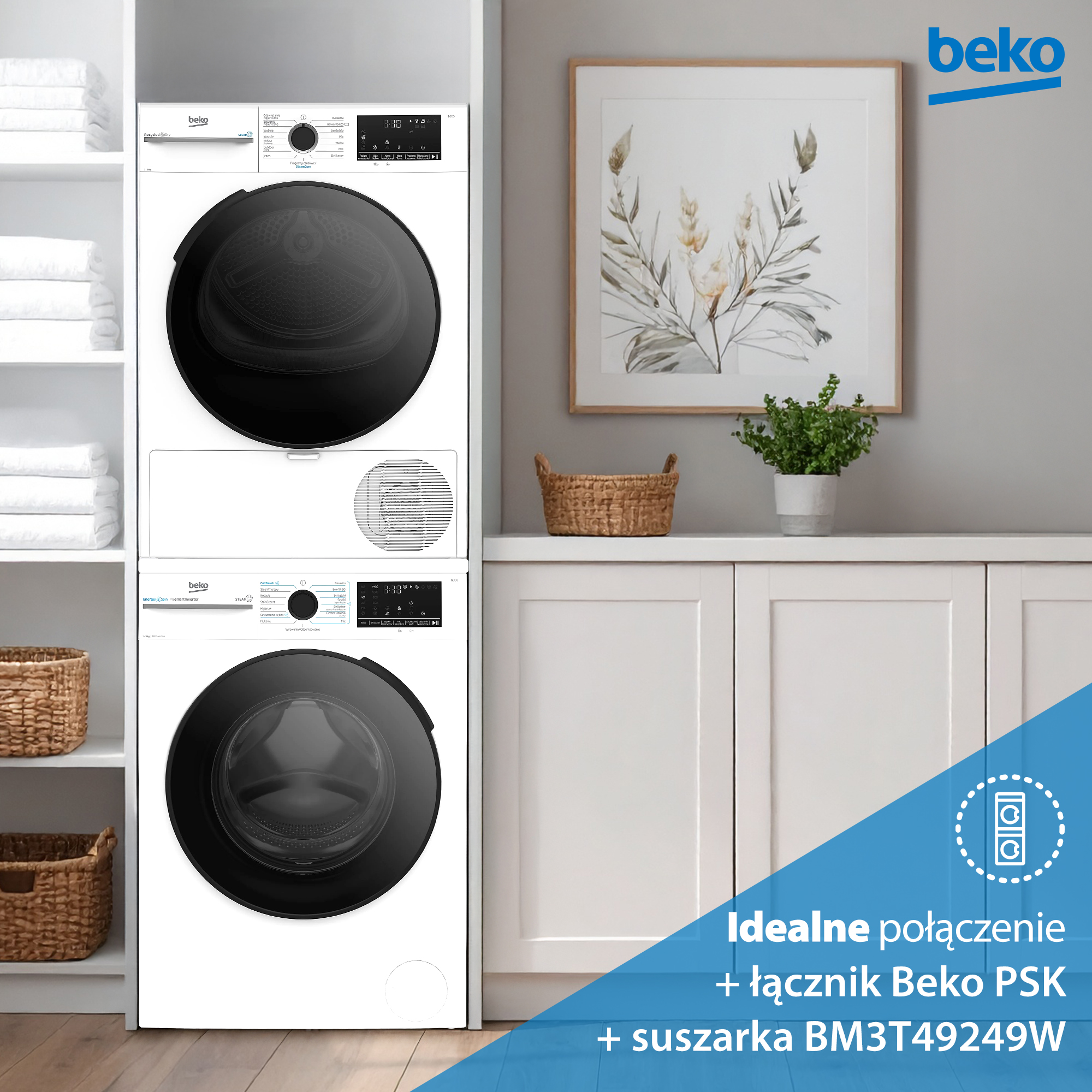Stojąca na sobie biała pralka i suszarka Beko. Obraz nad białą szafką. Półki po lewej stronie z ręcznikami.