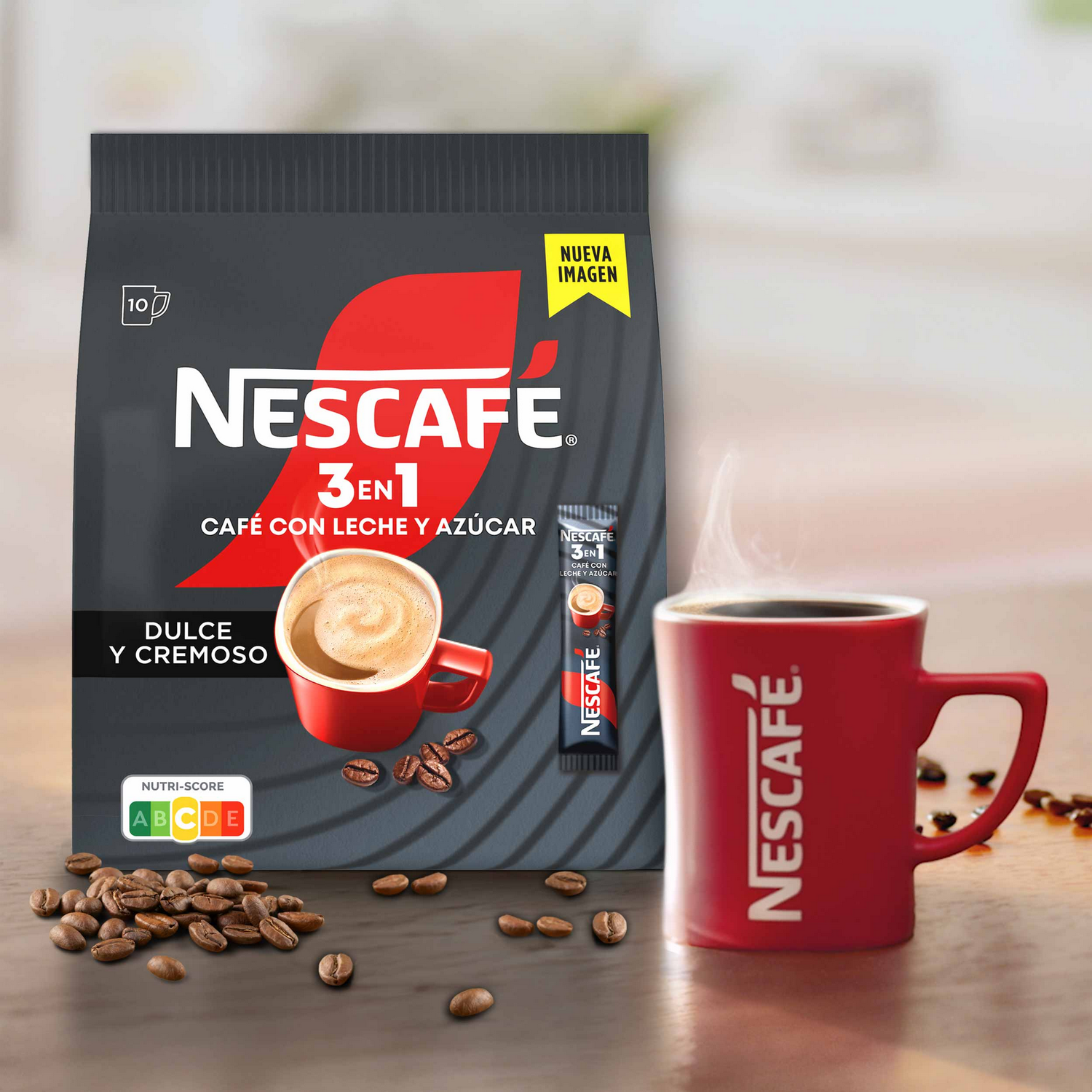 Un paquete de café Nescafe 3 en 1, una taza roja y granos de café sobre una superficie de madera. El vapor sale de la taza, creando una escena cálida.