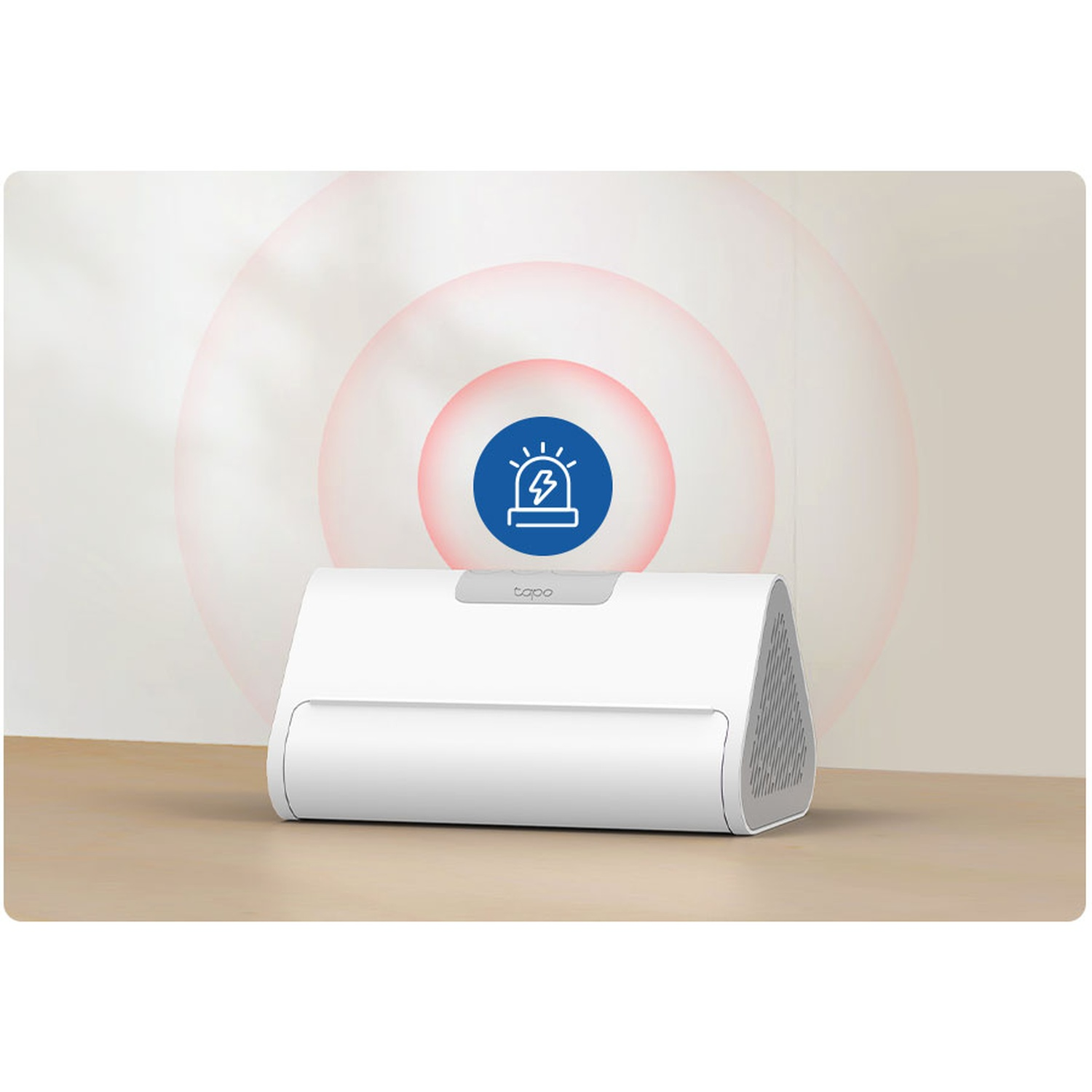 A white device with a blue alarm icon on top. Red circles emanate from the alarm. The device is on a wooden surface.