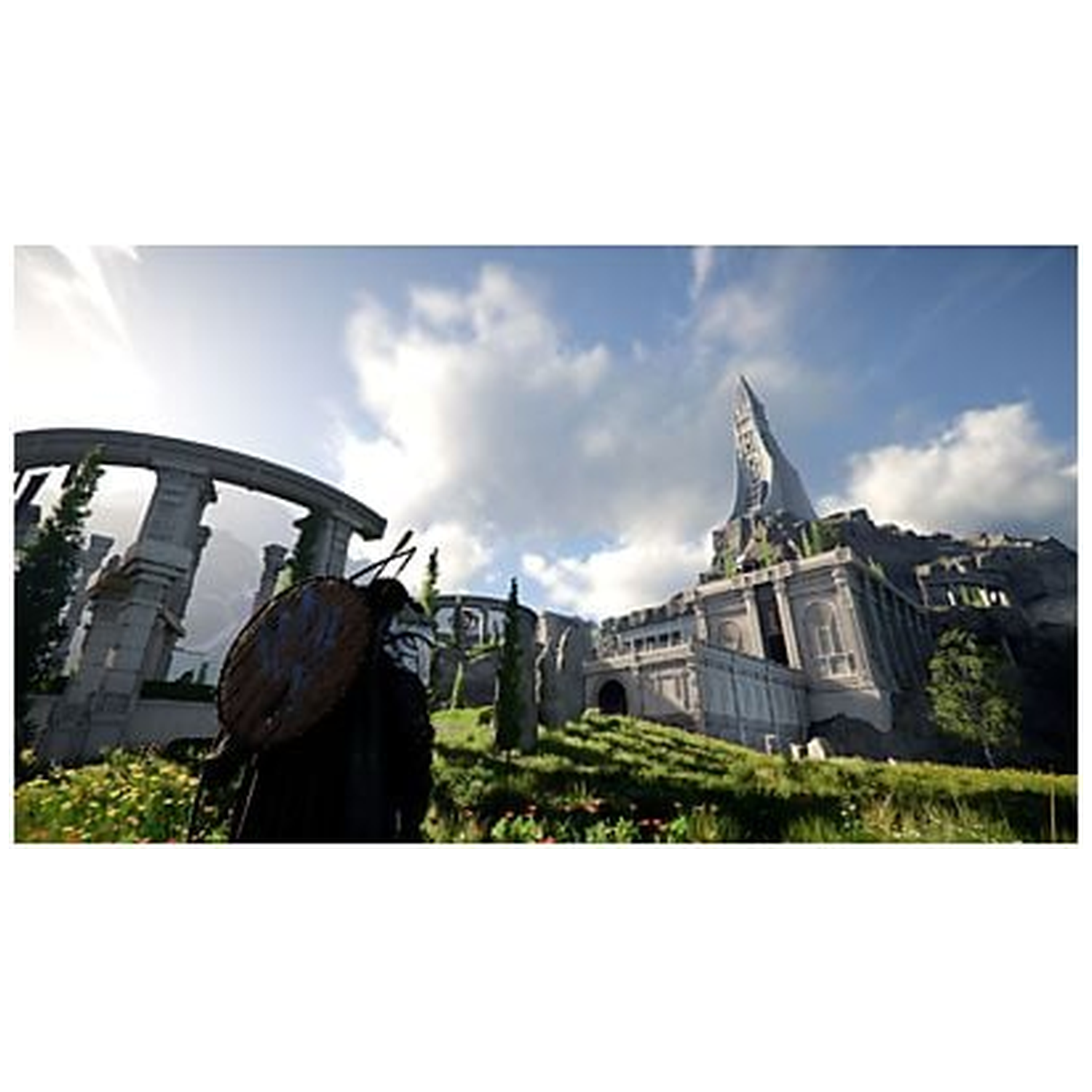 A person with a shield stands before a castle on a hill. Ruins in the background, blue sky with clouds.