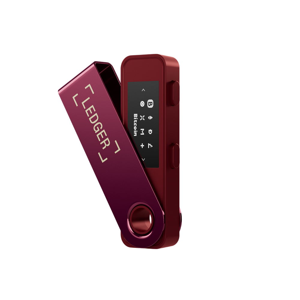 Kırmızı bir Ledger Nano S kripto donanım cüzdanı. Ekran, Bitcoin ve diğer kripto para birimi seçeneklerini görüntüler. Arka plan siyah.