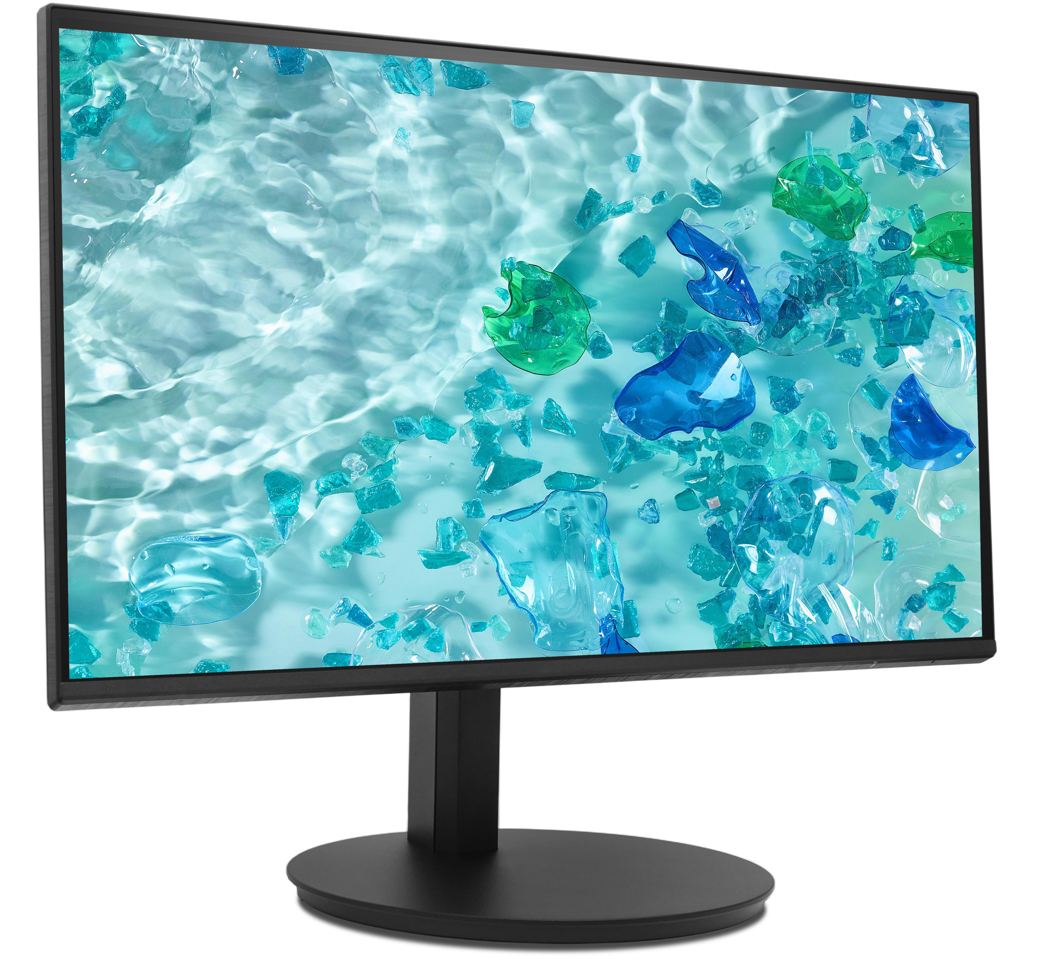 Der Monitor zeigt ein wasserähnliches Muster mit verstreuten abstrakten blauen und grünen Formen vor weißem Hintergrund.