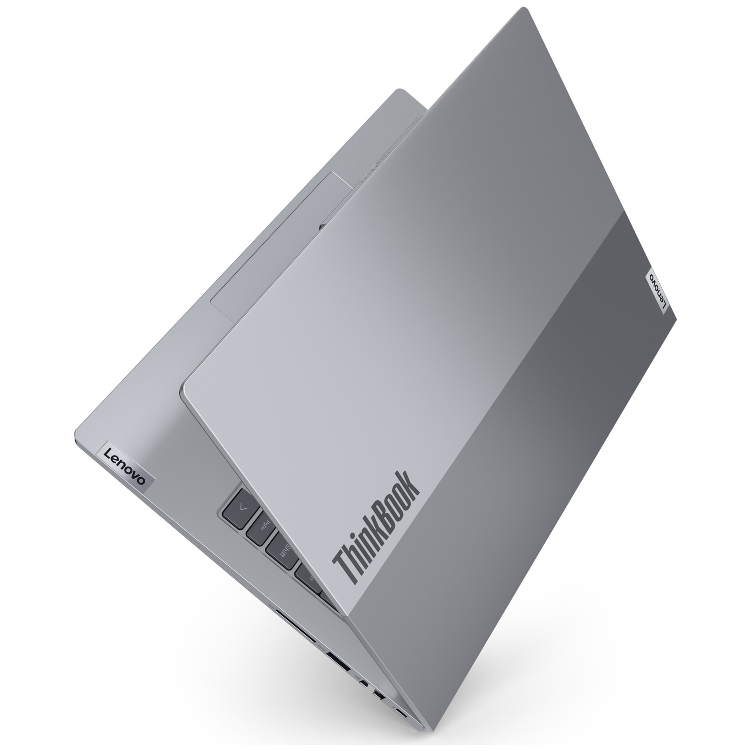 A gray Lenovo ThinkBook laptop is partially open. The screen is up, revealing the keyboard. The Lenovo logo is visible.