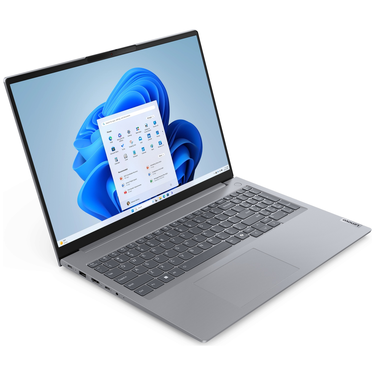 Un ordinateur portable Lenovo est ouvert, affichant une interface Windows 11. L'écran montre le bureau et un menu. Clavier et pavé tactile sont visibles.