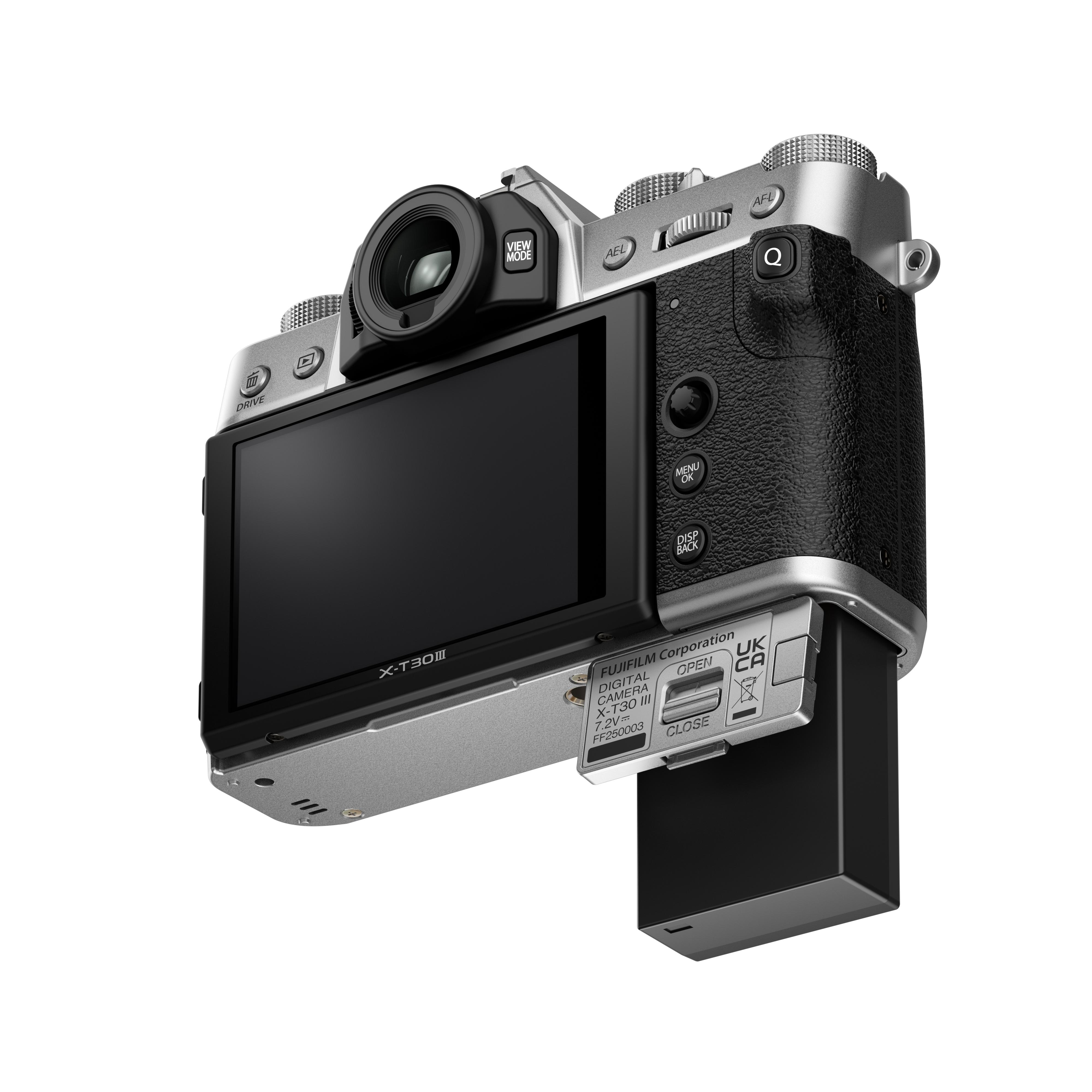 Silber-schwarze Fujifilm X-T30 III Kamera, Bildschirm offen, Akku entfernt. Weißer Hintergrund.