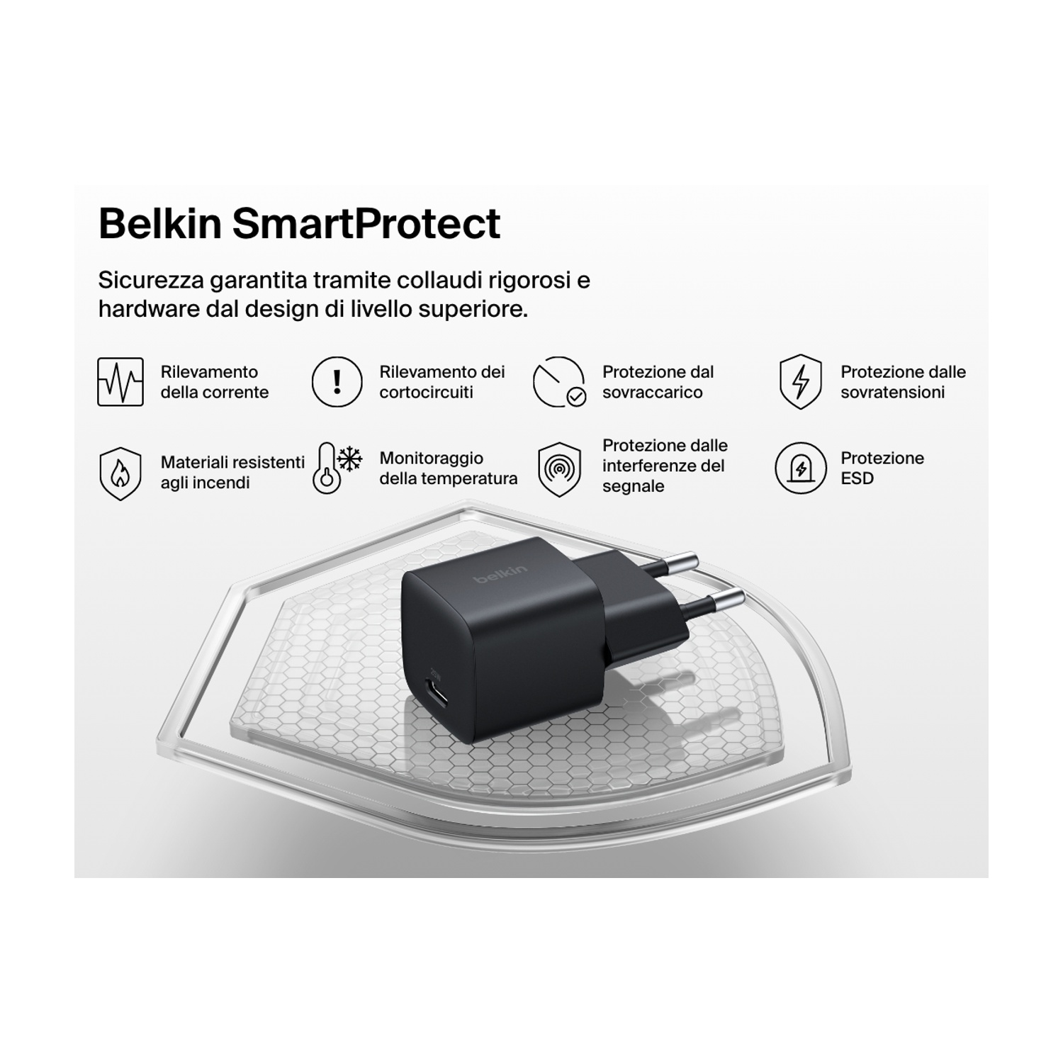 Un caricabatterie Belkin nero è posizionato su una piattaforma esagonale trasparente. Il testo descrive caratteristiche di sicurezza come la protezione da sovraccarico e sovratensione.