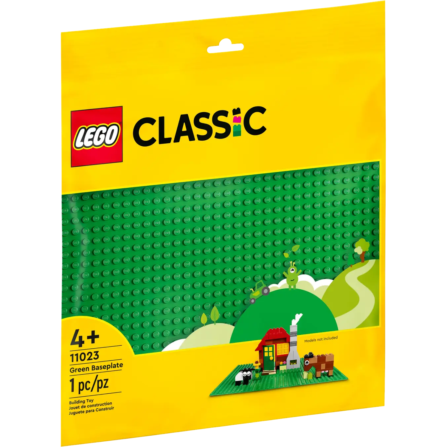 A LEGO Classic package with a green baseplate. It features a red house, sheep, and other models. The background is yellow.