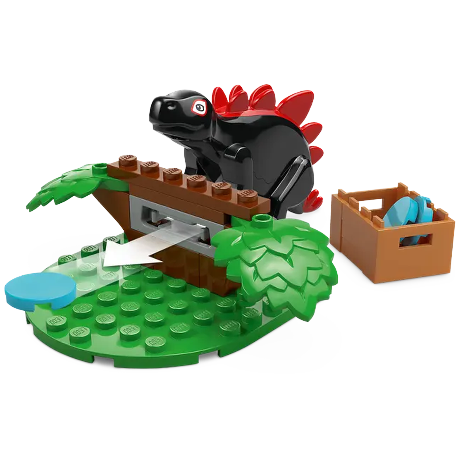 A black Lego dinosaur with red spines, green base, brown tree, and a wooden box with blue items.