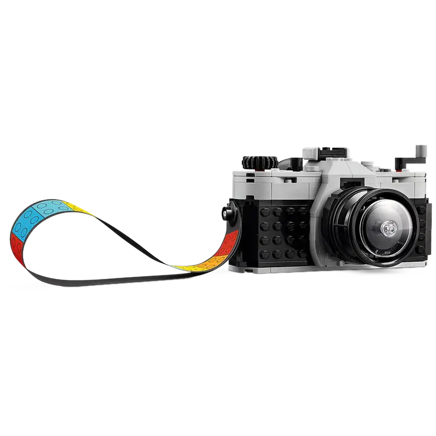 A Lego camera with a colorful strap. The camera is gray and black with a large lens. The strap is blue, yellow, and red.