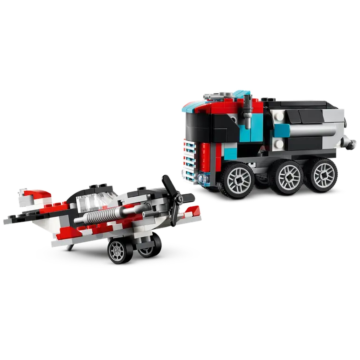 A toy airplane and a truck made of colorful blocks are on a white surface. The airplane has a propeller.