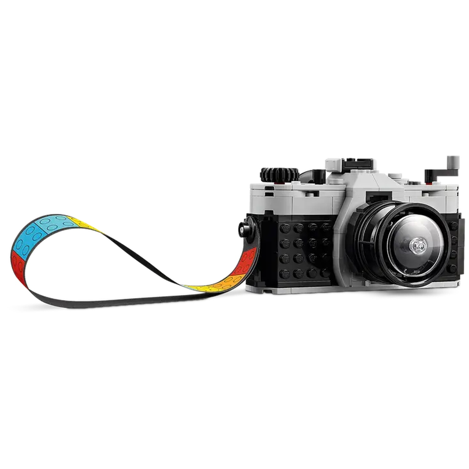 A Lego camera with a colorful strap. The camera is gray and black with a black lens. The strap is blue, yellow, red, and black.