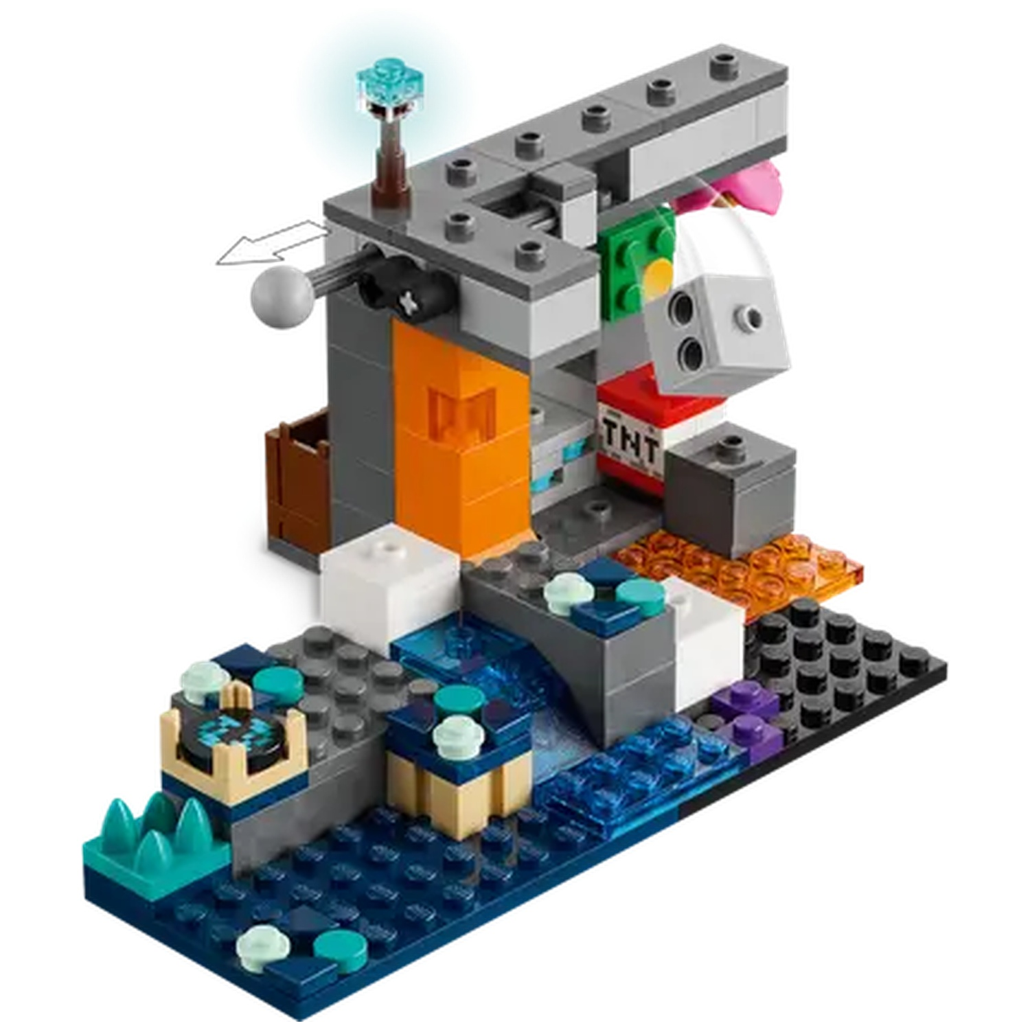 Une structure Lego avec des blocs gris, orange et bleus. Elle comprend une tour lumineuse, une boîte de TNT et un élément de bloc rotatif.