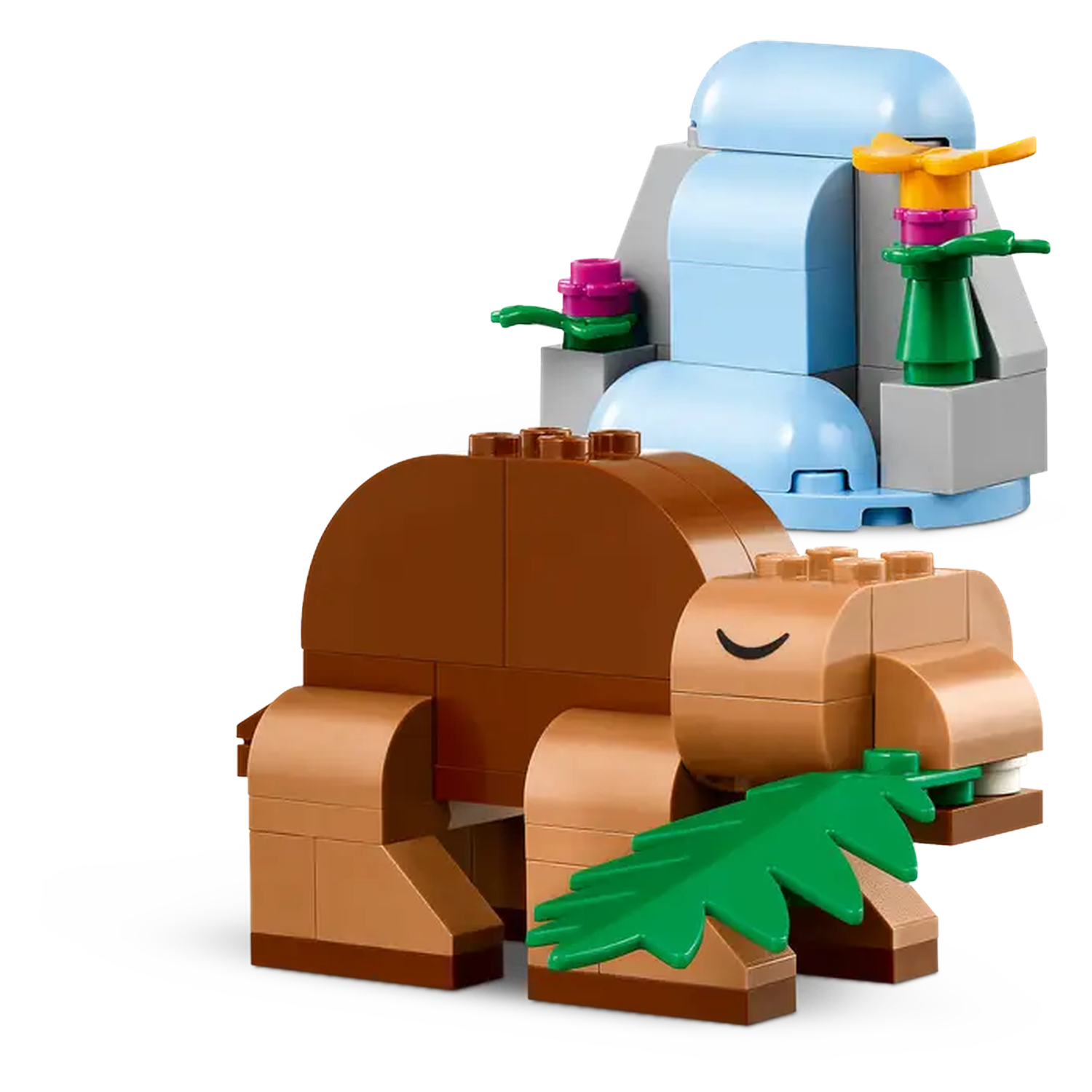 A Lego scene features a brown hippo with a leaf in its mouth. Behind, there's a blue waterfall and other colorful Lego parts.