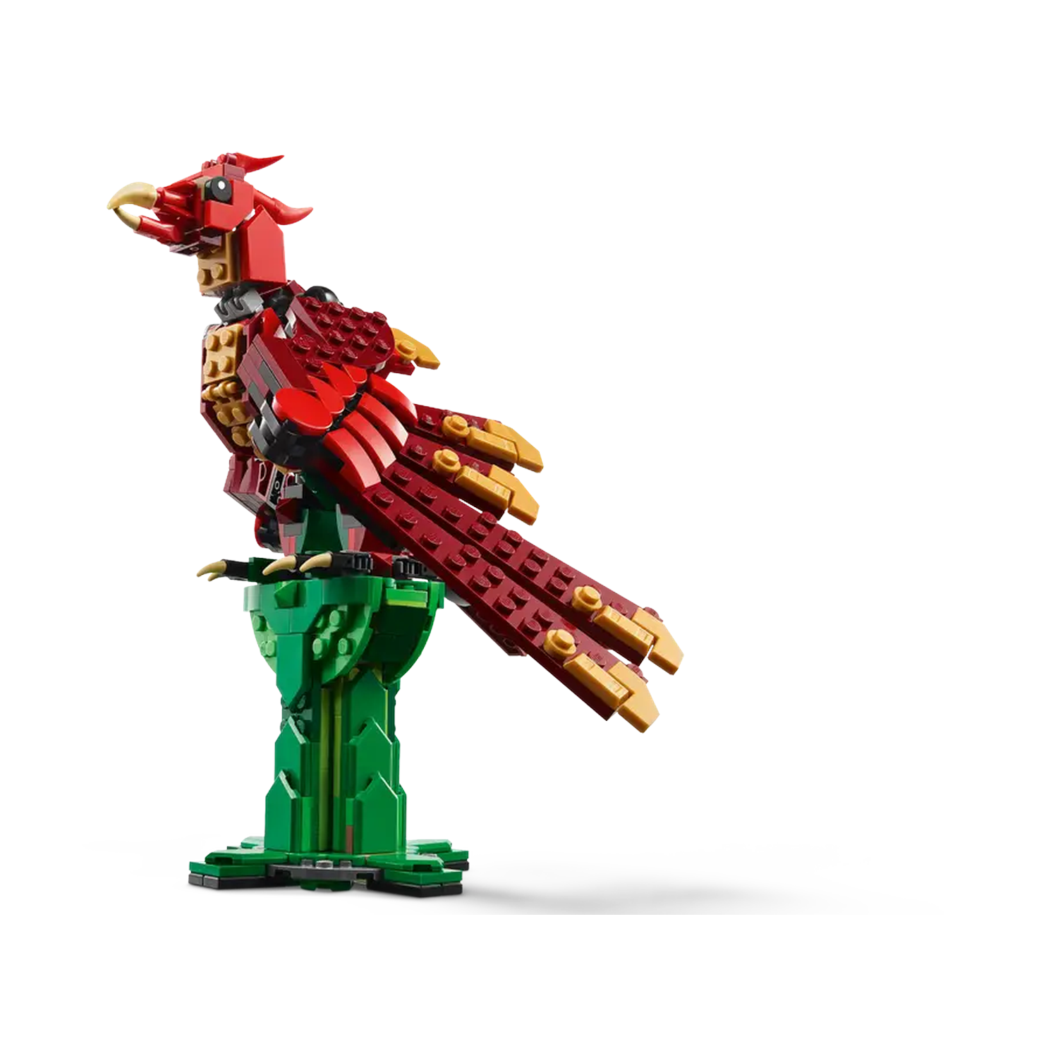 A Lego phoenix with red, gold, and green parts. It is perched on a green stand against a white background.