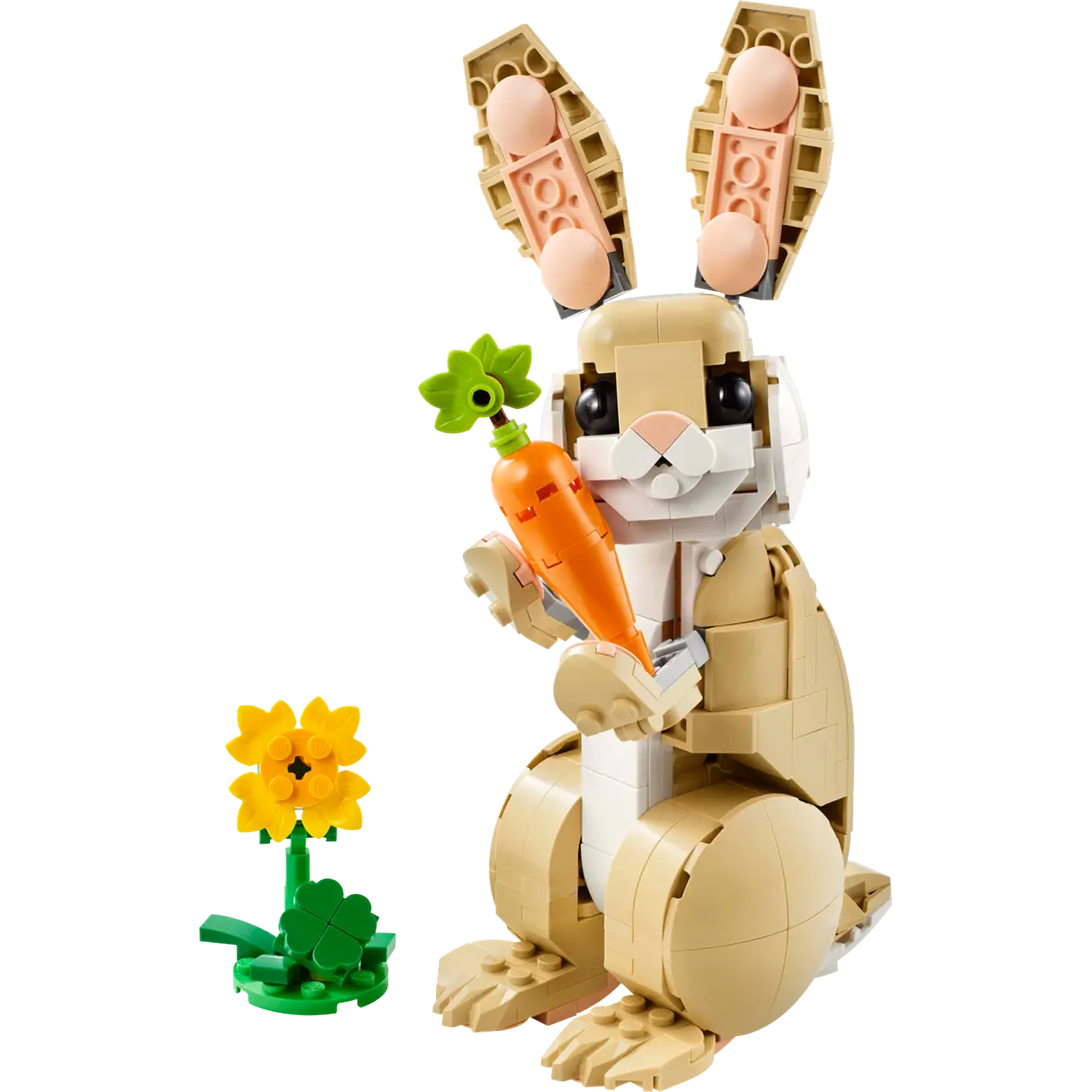 A Lego bunny holding a carrot. A yellow flower and clover sit beside it. The bunny is tan, white and pink.