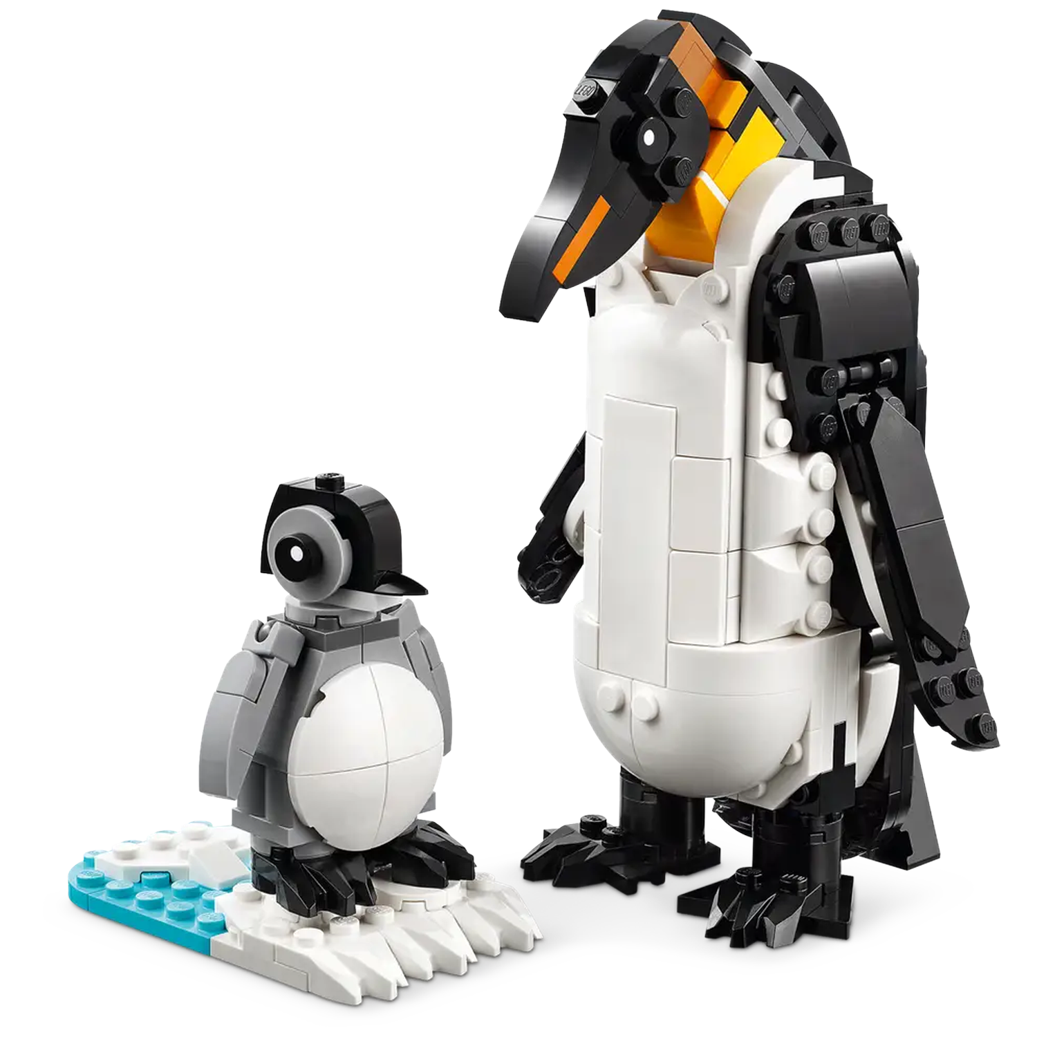 Two Lego penguins, one adult and one chick, stand on a white surface with a blue and white ice base. The adult is taller.